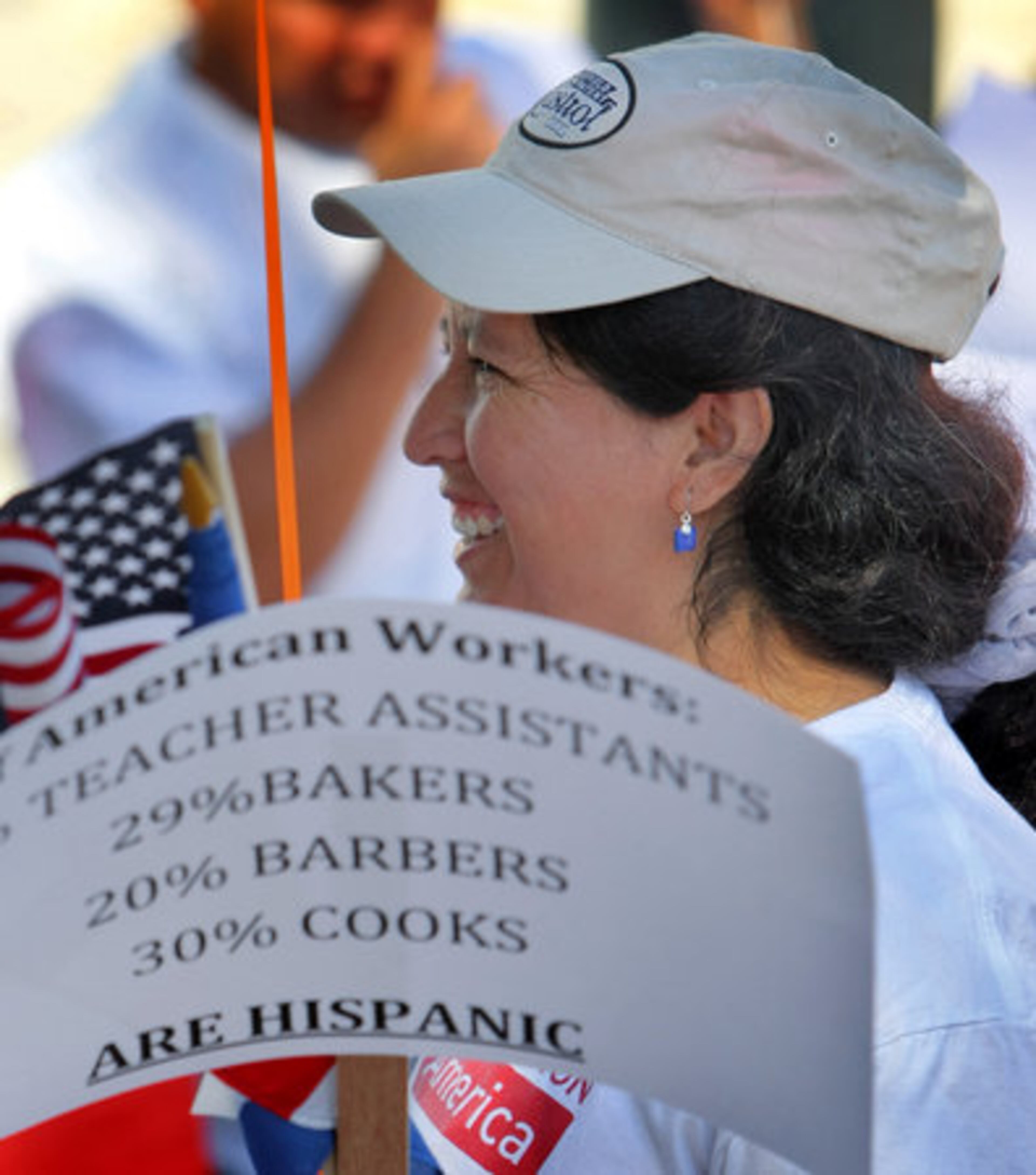 Angelina Garcia of Roswell smiles as she gets her sign at Marietta Street and Centennial Olympic Park Drive.