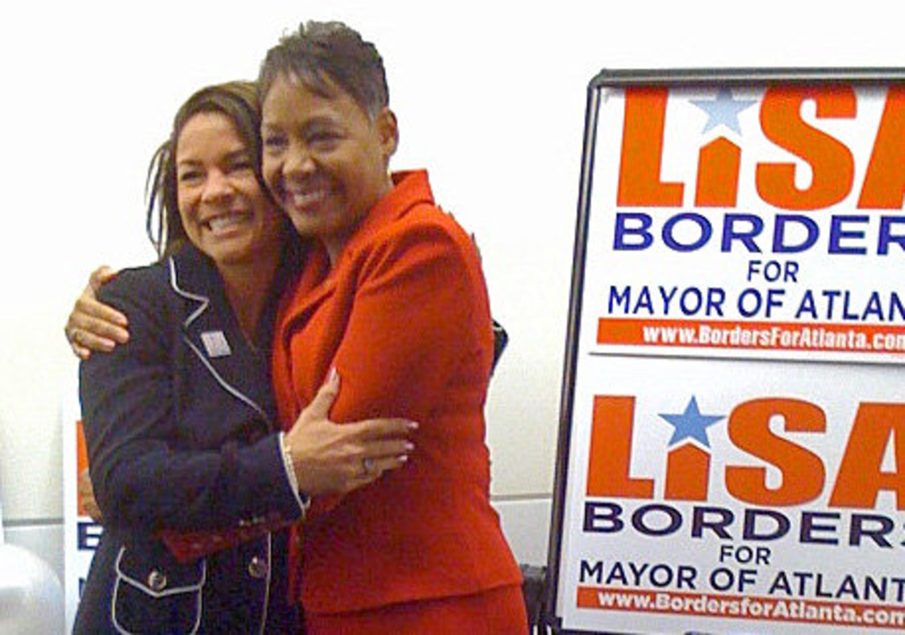 Lisa Borders hugs supporter Belinda Stubblefield as Borders arrives at her election party at the W Hotel in downtown Atlanta.
