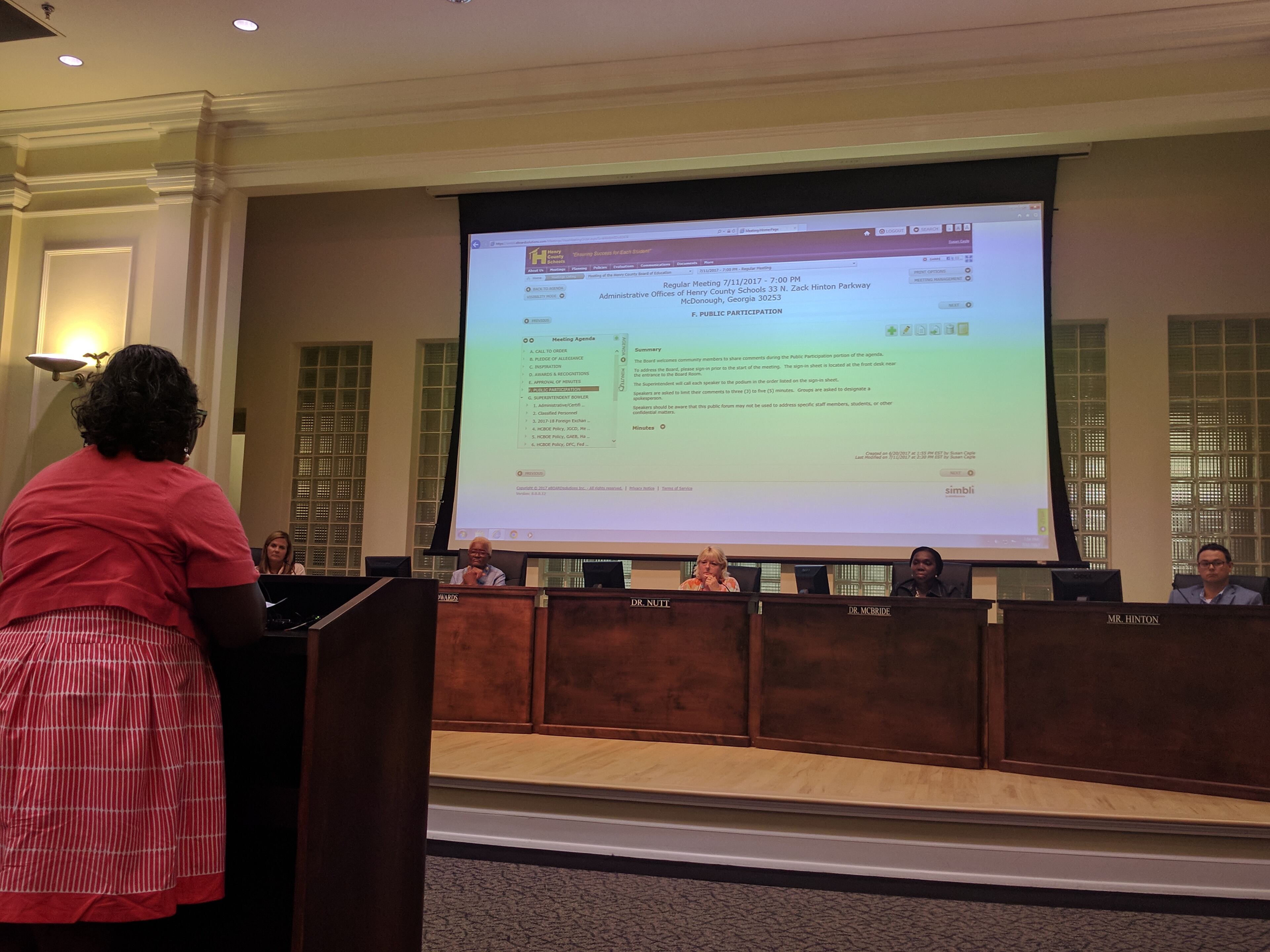 Members of the Henry County Board of Education listen to citizens express concerns over contract negotiations with superintendent candidate Dr. Timothy Gadson. AJC staff photo