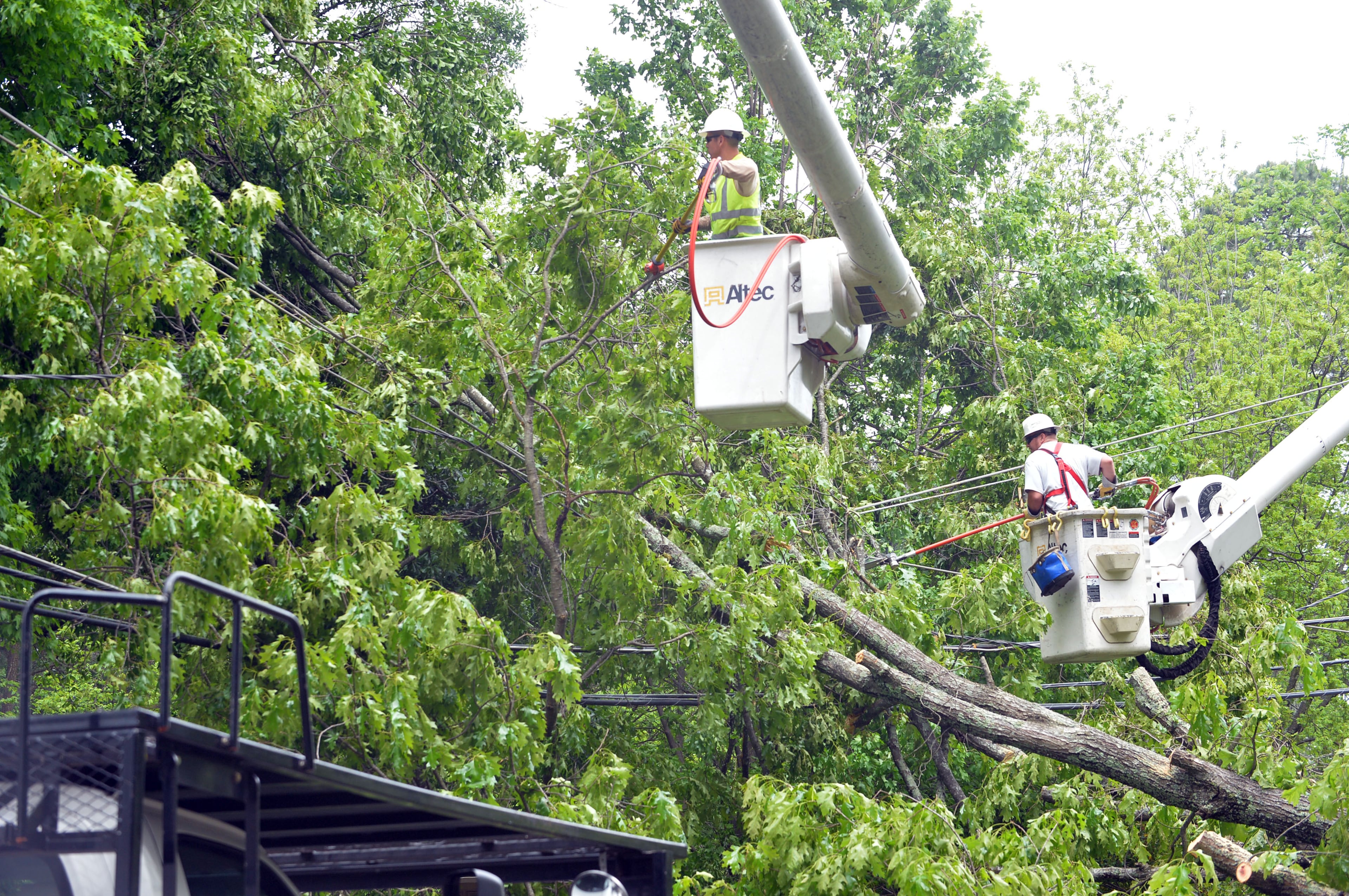 Georgia Power and Trees Inc crews work to remove a large tree that fell on power lines in the 1900 block of Idlewood Road in Tucker Tuesday April 29. 2014. KENT D. JOHNSON/KDJOHNSON@AJC.COM