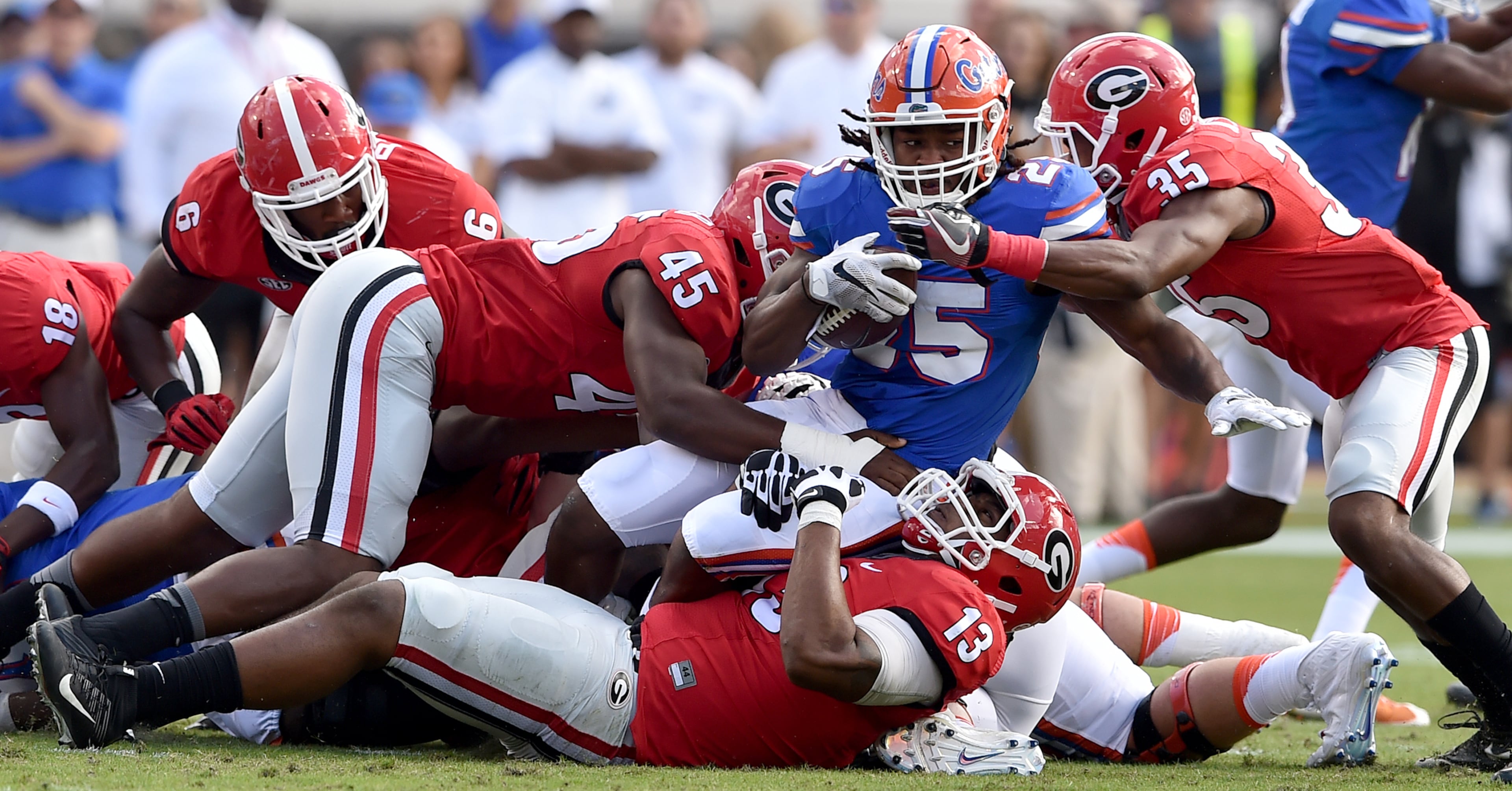 October 29 Jacksonville, FL : Florida Gators running back Jordan Scarlett is stopped by Jonathan Ledbetter(13) Reggie Carter (45) and Aaron Davis during the first quarter at EverBank Field in Jacksonville Saturday October 29, 2016. BRANT SANDERLIN/BSANDERLIN@AJC.COM