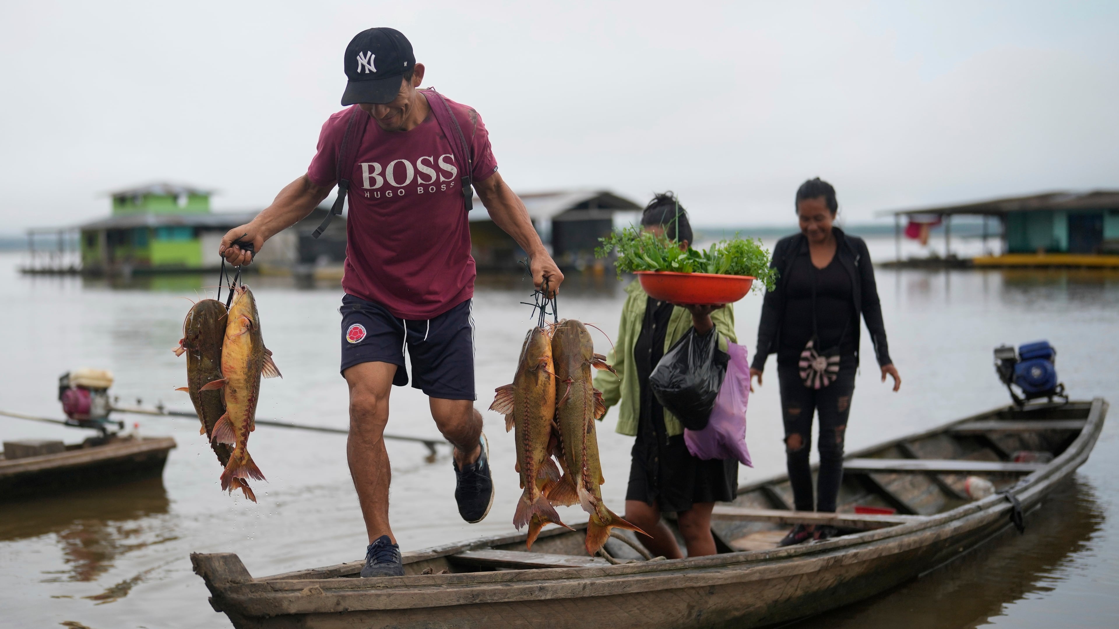 FILE - A man unloads fresh fish from a boat in Puerto Narino, Colombia, along the Amazon River, Sept. 7, 2025. (AP Photo/Fernando Vergara, File)