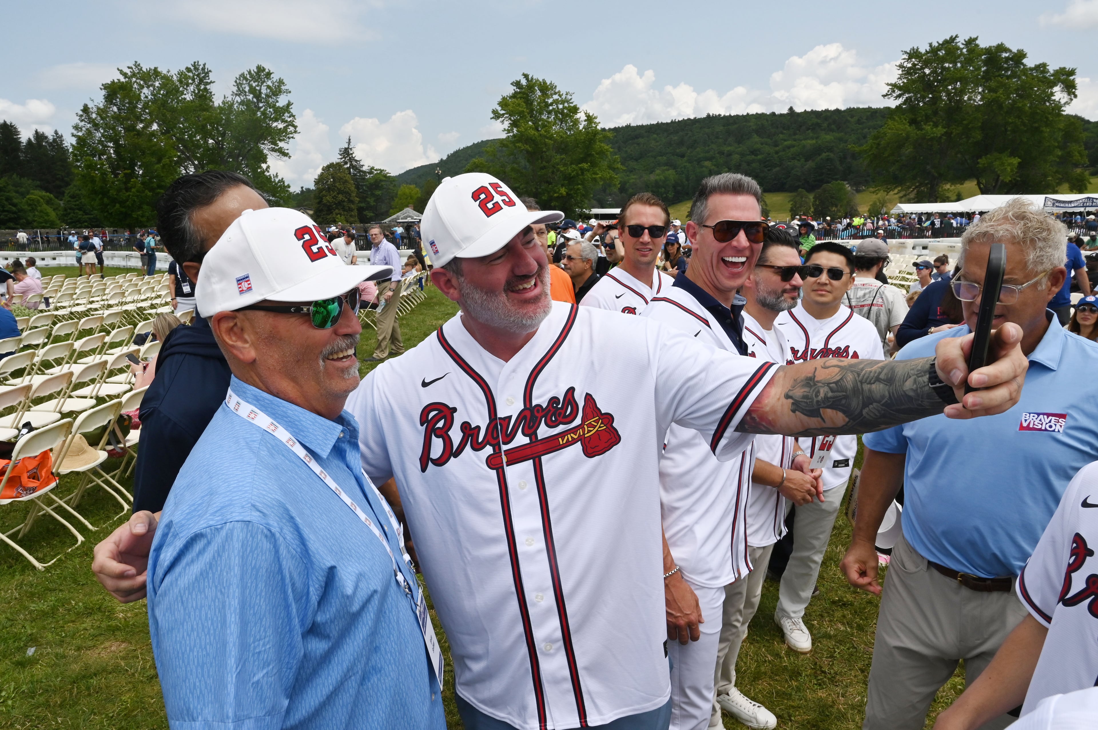 Former Atlanta Braves manager Brian Snitker, left, poses with a Braves fan before the 2026 National Baseball Hall of Fame Induction Ceremony at the Clark Sports Center on Sunday, July 26, 2026, in Cooperstown, N.Y. Braves centerfielder Andruw Jones is set for induction into the National Baseball Hall of Fame as part of the Class of 2026, alongside Carlos Beltrán and Jeff Kent. (Hyosub Shin/AJC)