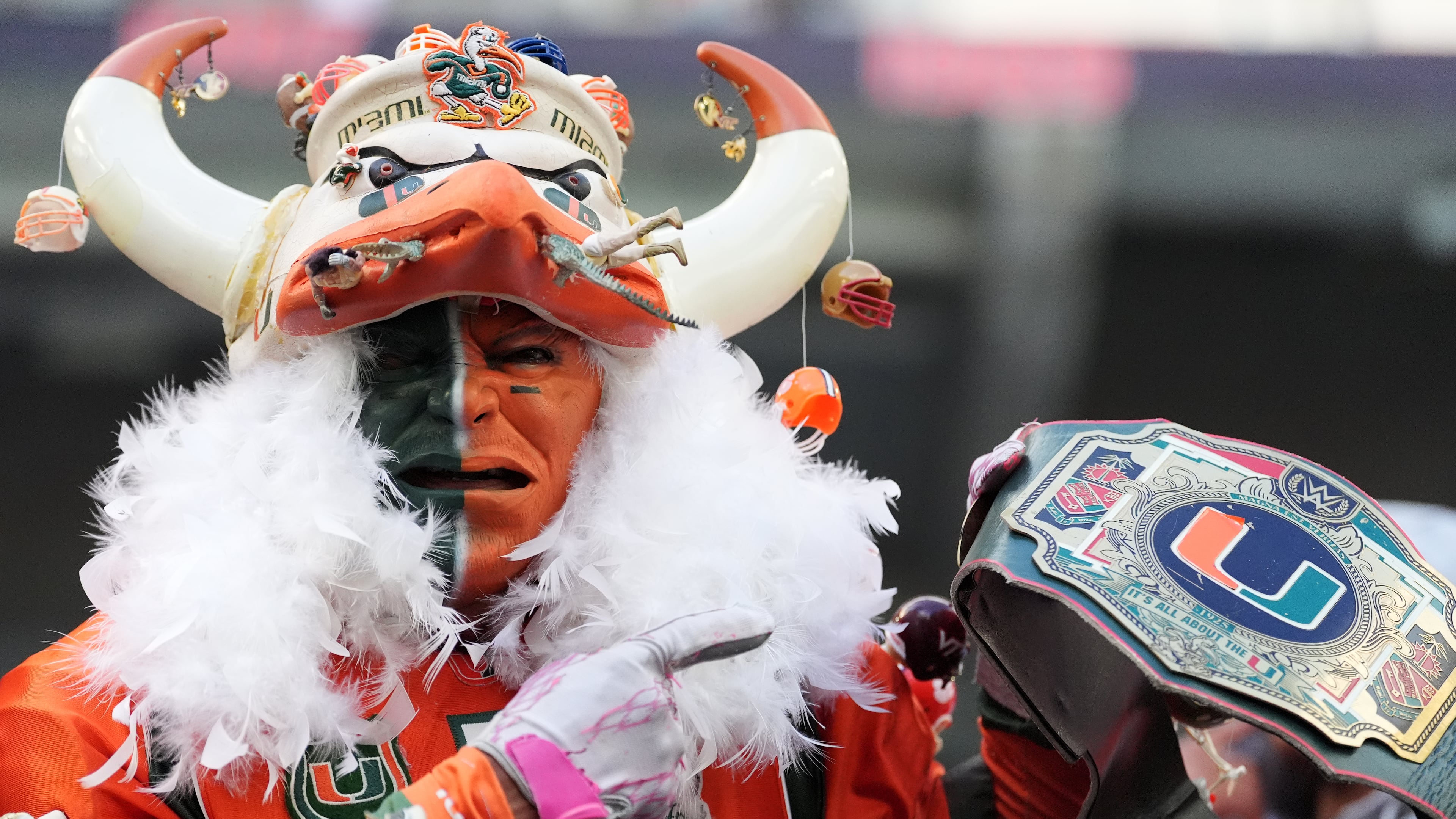 A Miami fan stands in the stands during the second half of an NCAA college football game between Miami and Pittsburgh, Saturday, Oct. 24, 2026, in Miami Gardens, Fla. (AP Photo/Rebecca Blackwell)