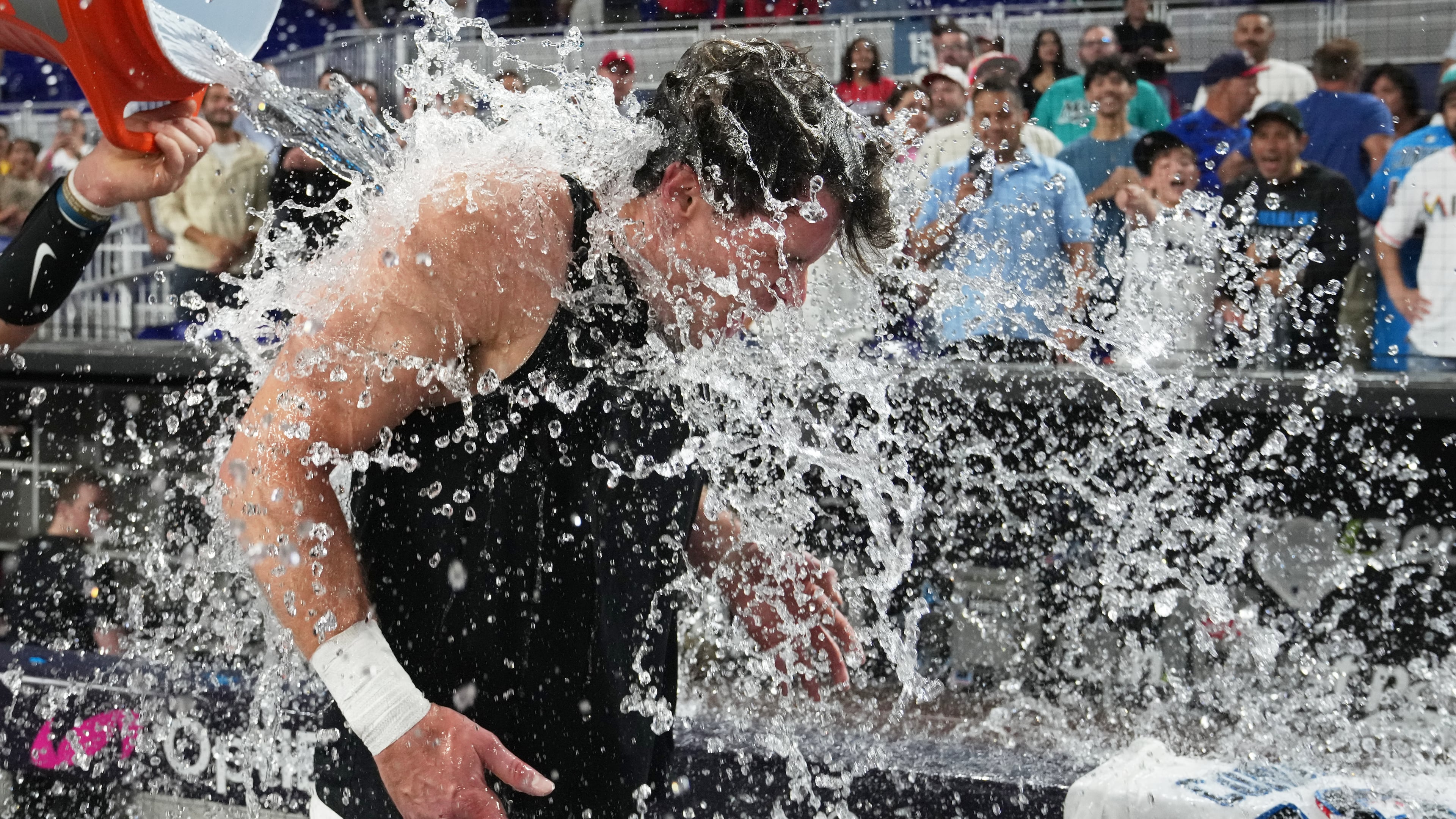 Miami Marlins' Griffin Conine, right, is doused after hitting a walk off single to defeat the Philadelphia Phillies in the the ninth inning of a baseball game, Monday, July 27, 2026, in Miami. (AP Photo/Lynne Sladky)