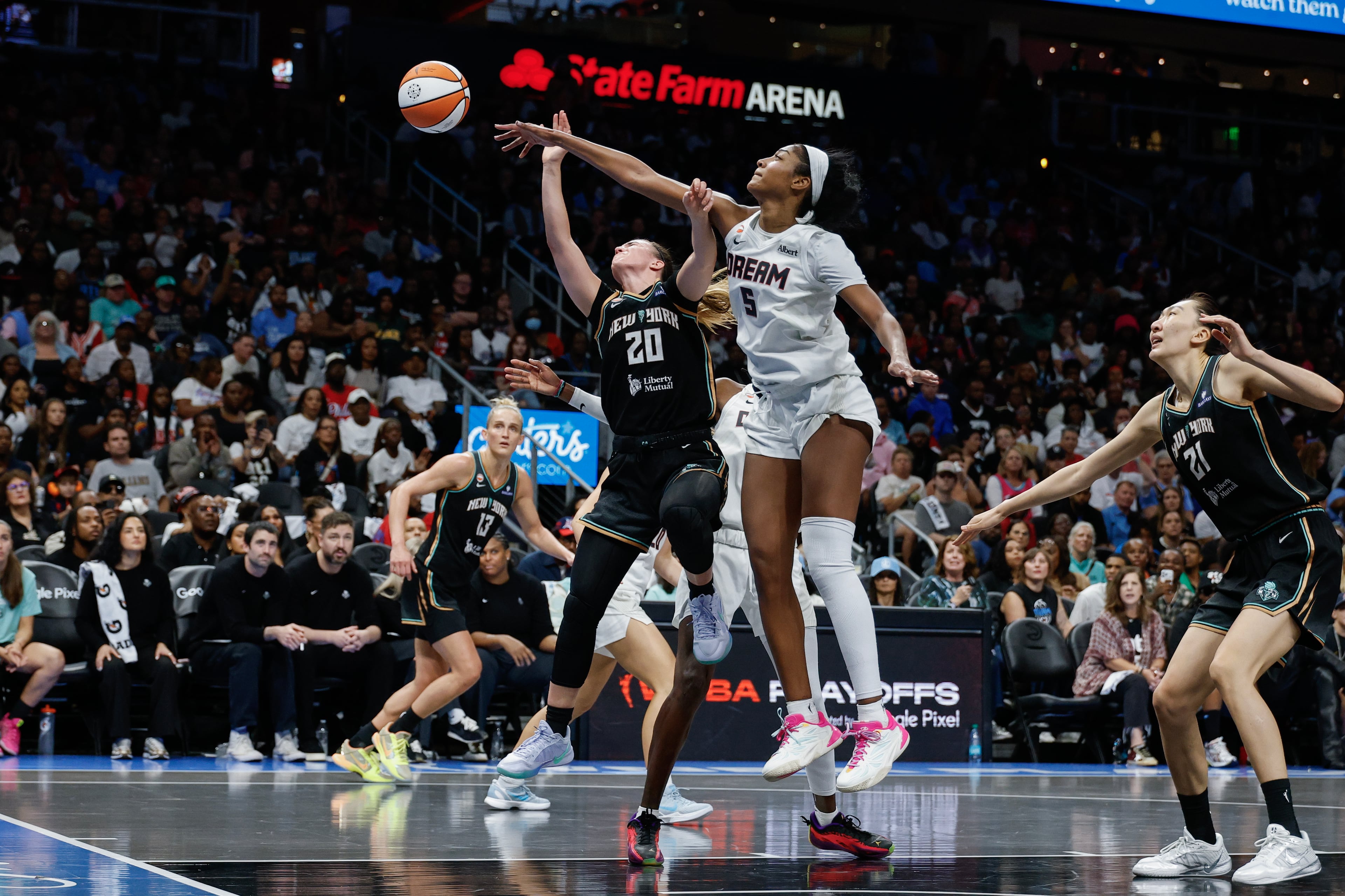Atlanta Dream forward Angel Reese (5) defends against New York Liberty guard Sabrina Ionescu (20) during the second half of a WNBA semifinal playoff game 1 between the Atlanta Dream and the New York Liberty, Sunday, Oct. 4, 2026, in Atlanta. (Erik S. Lesser for the AJC)