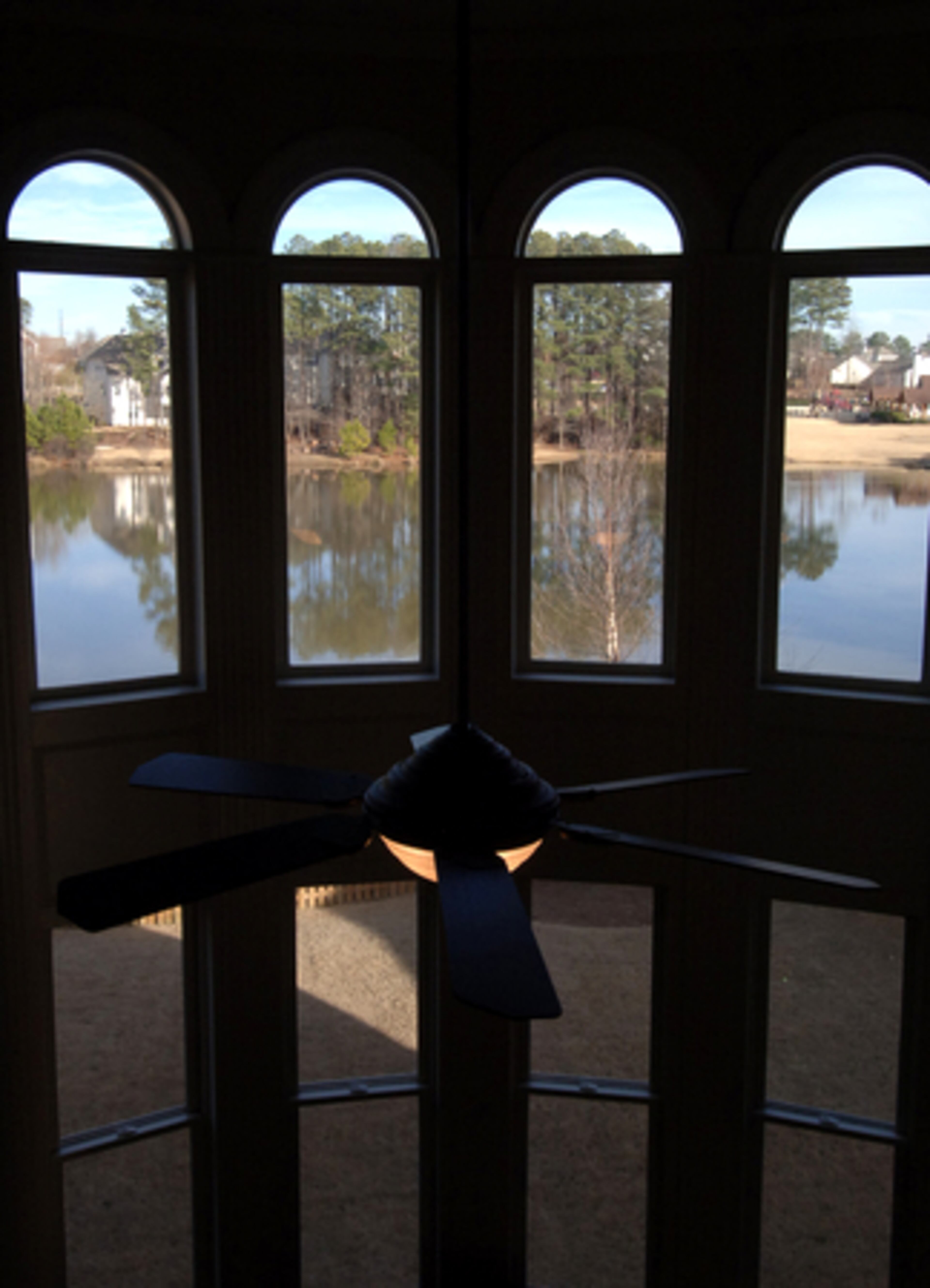 Looking out the living room window from upstairs, you can see the neighborhood lake and nearby amenities.