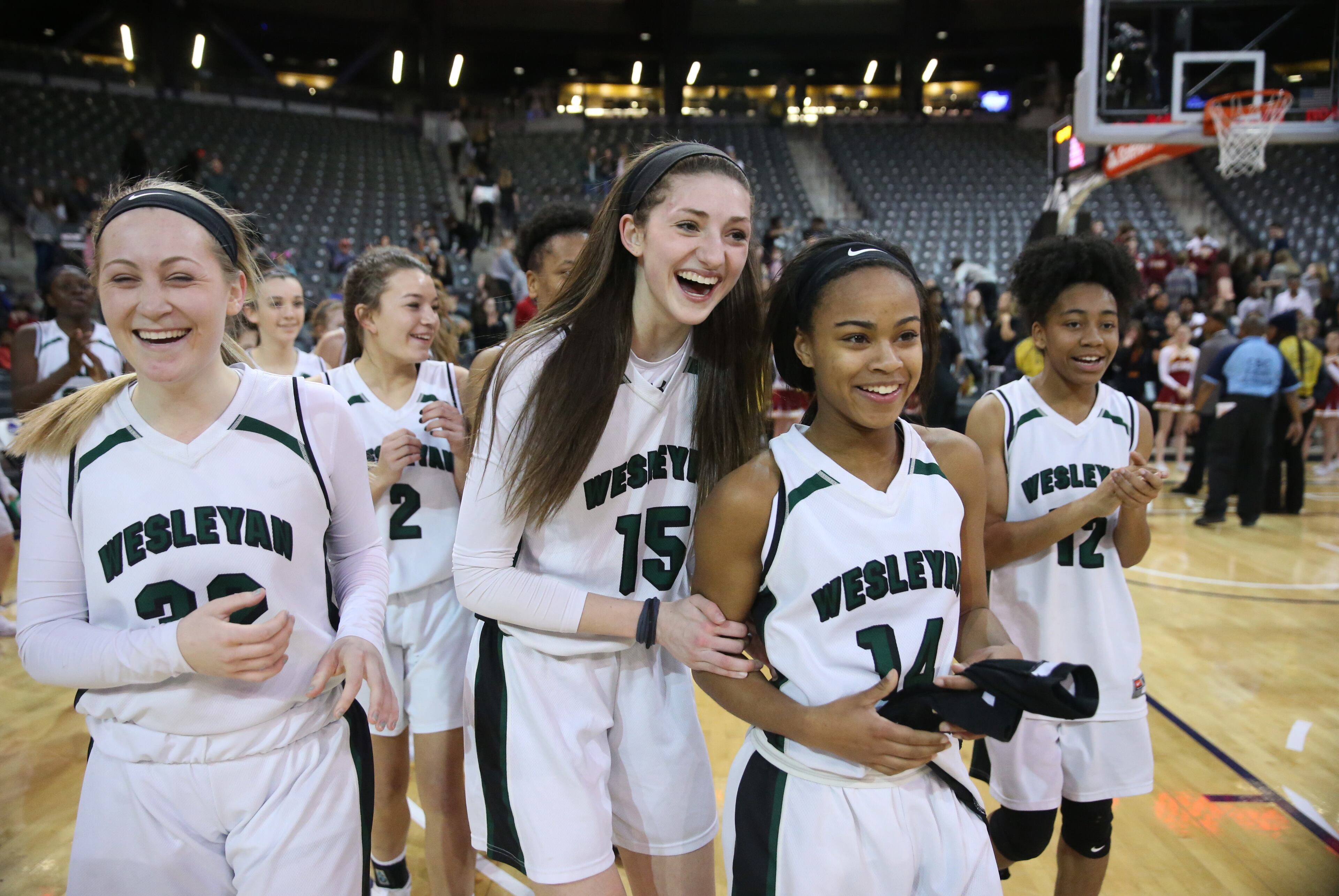 March 9, 2018 - Atlanta, Ga: Wesleyan's Callie Weaver (32), Sutton West (15), Amaya Register (14), and Paige Lyons (12) celebrate their win against Holy Innocents during the GHSA Class A Private Girls State Championship at McCamish Pavilion Friday, March 9, 2018, in Atlanta. Wesleyan won 61-44. PHOTO / JASON GETZ