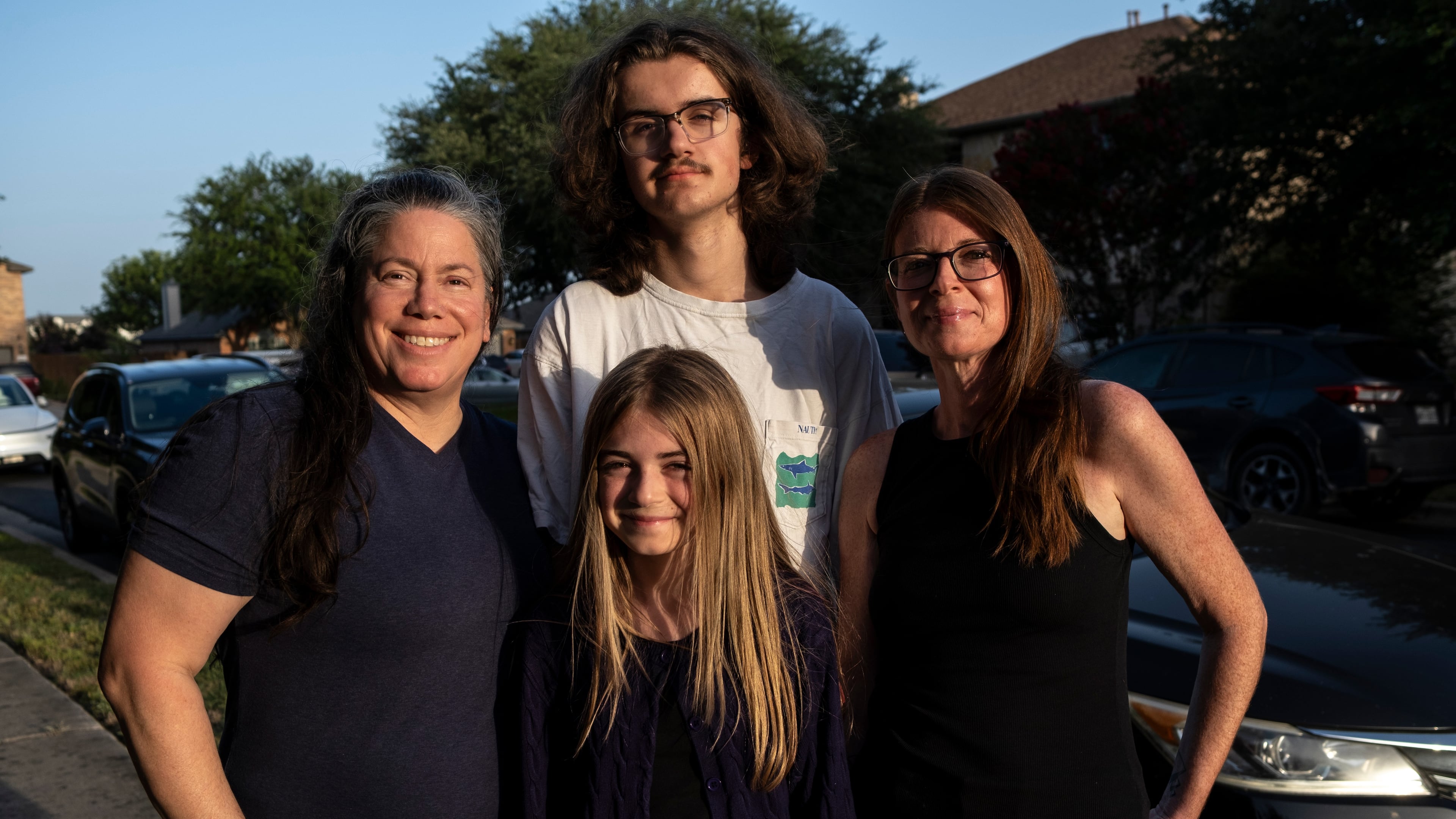 Jamie Corum, her children Ivy Edgar, 10, Cash Edgar, 17, and wife Jessica Edgar-Corum pose for a portrait in their neighborhood on Monday, June 29, 2026, in Pflugerville, Texas. (AP Photo/Joel Angel Juarez)