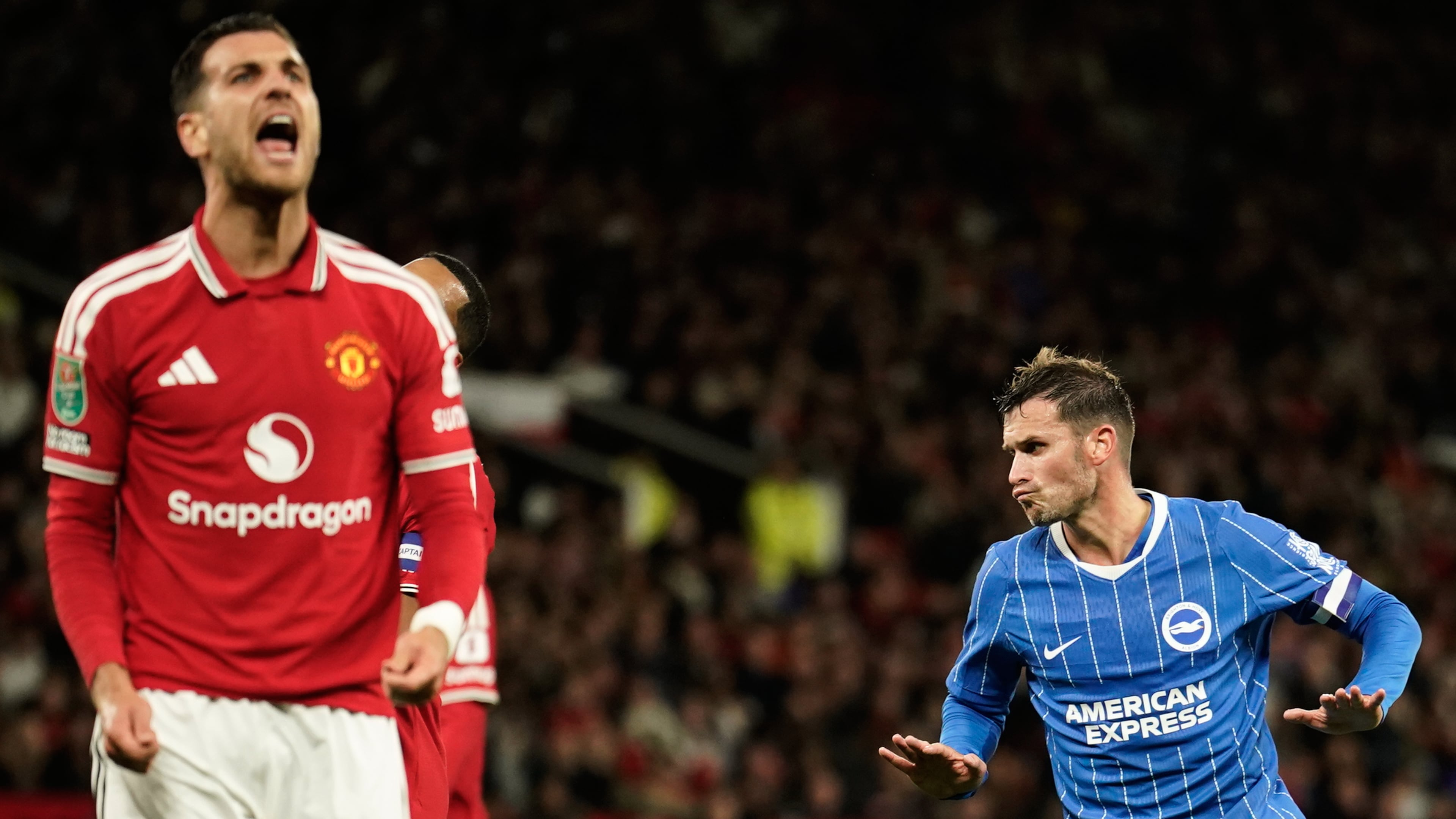 Brighton's Pascal Gross, right, celebrates after scoring his side's second goal during the English League Cup third round soccer match between Manchester United and Brighton and Hove Albion in Manchester, England, Wednesday, Sept. 16, 2026. (AP Photo/Dave Thompson)