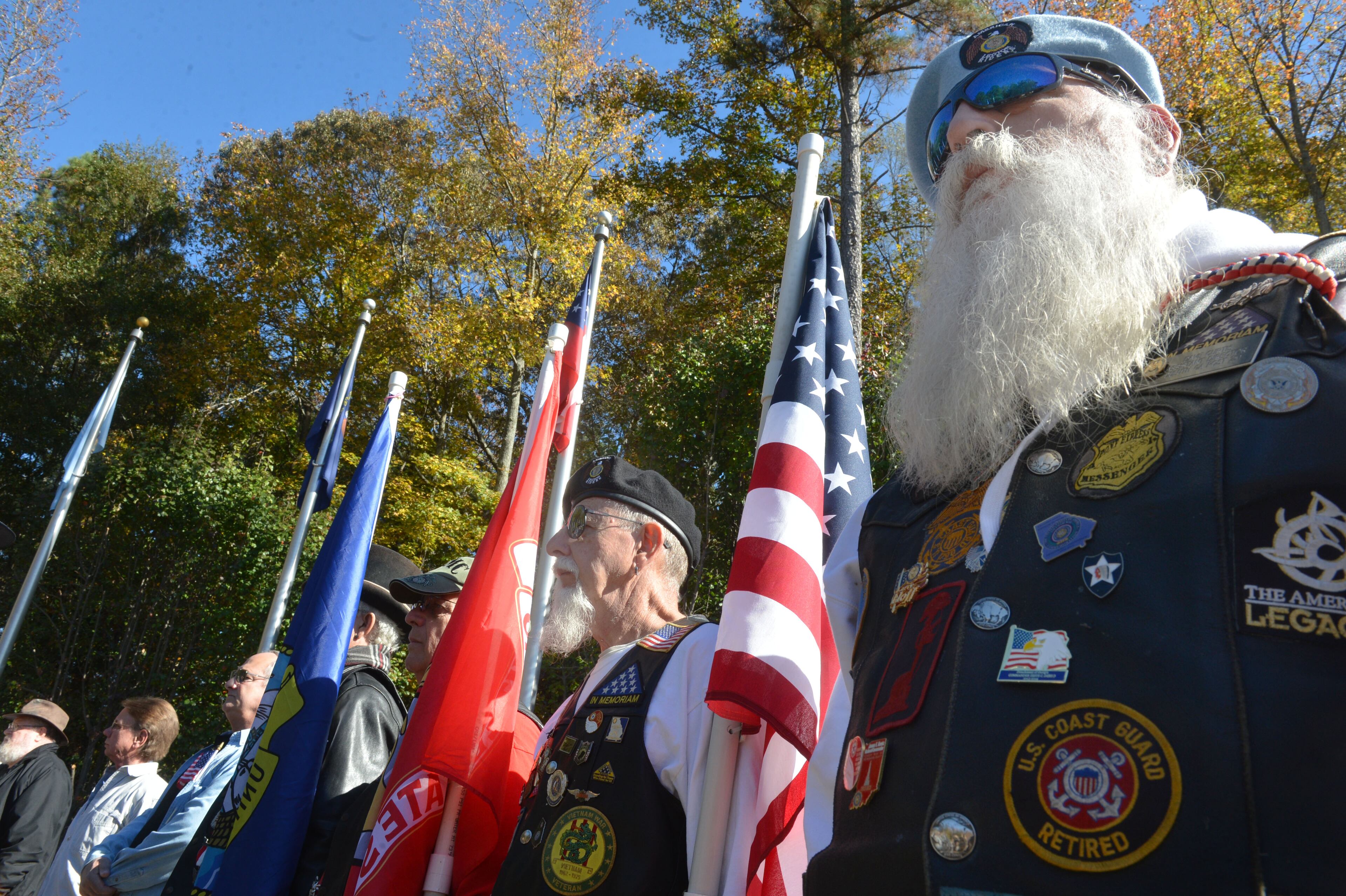 Veterans Frank Hendershot, of Lawrenceville (left) and Dave Curtis of Lilburn stand at attention as Vietnam era veterans are honored Nov. 11, 2013 at the Fallen Heroes Memorial in Lawrenceville during Gwinnett County's Veterans Day Ceremony.