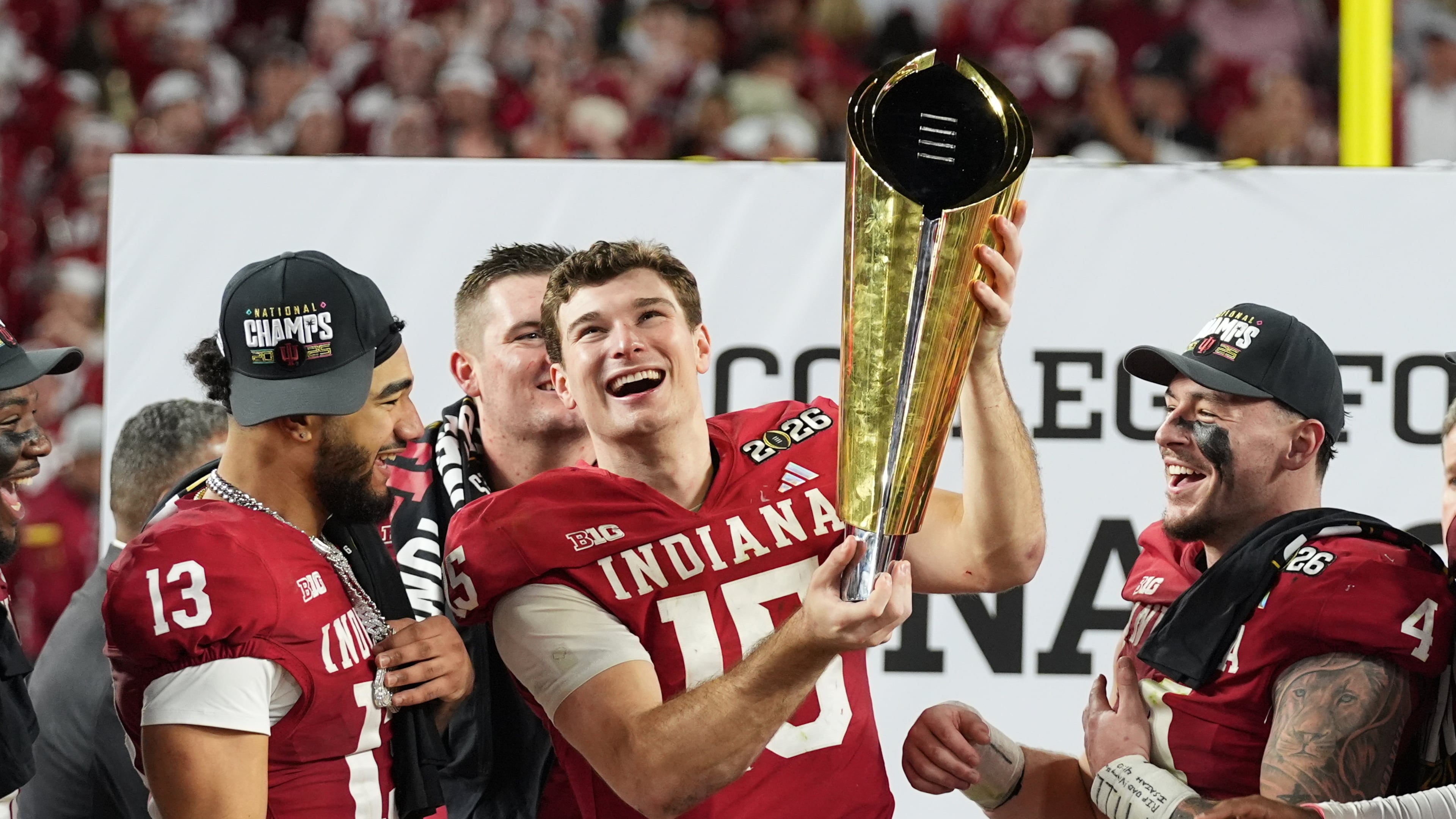FILE - Indiana quarterback Fernando Mendoza holds the trophy after Indiana defeated Miami in a College Football Playoff national championship game in Miami Gardens, Fla., Jan. 19, 2026, (AP Photo/Lynne Sladky, File)