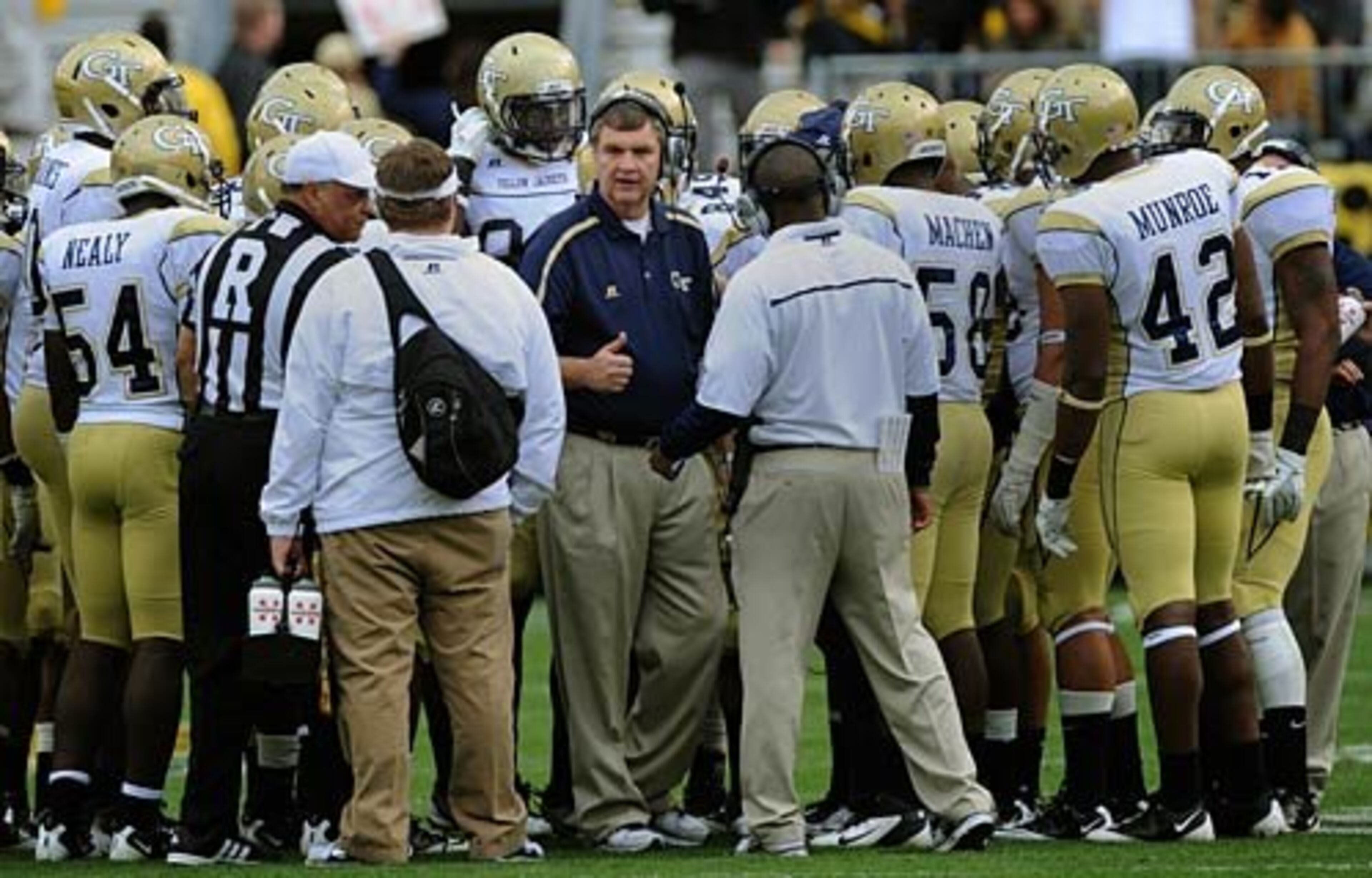 Georgia Tech head coach Paul Johnson talks strategy with his team during a timeout in the fourth quarter.