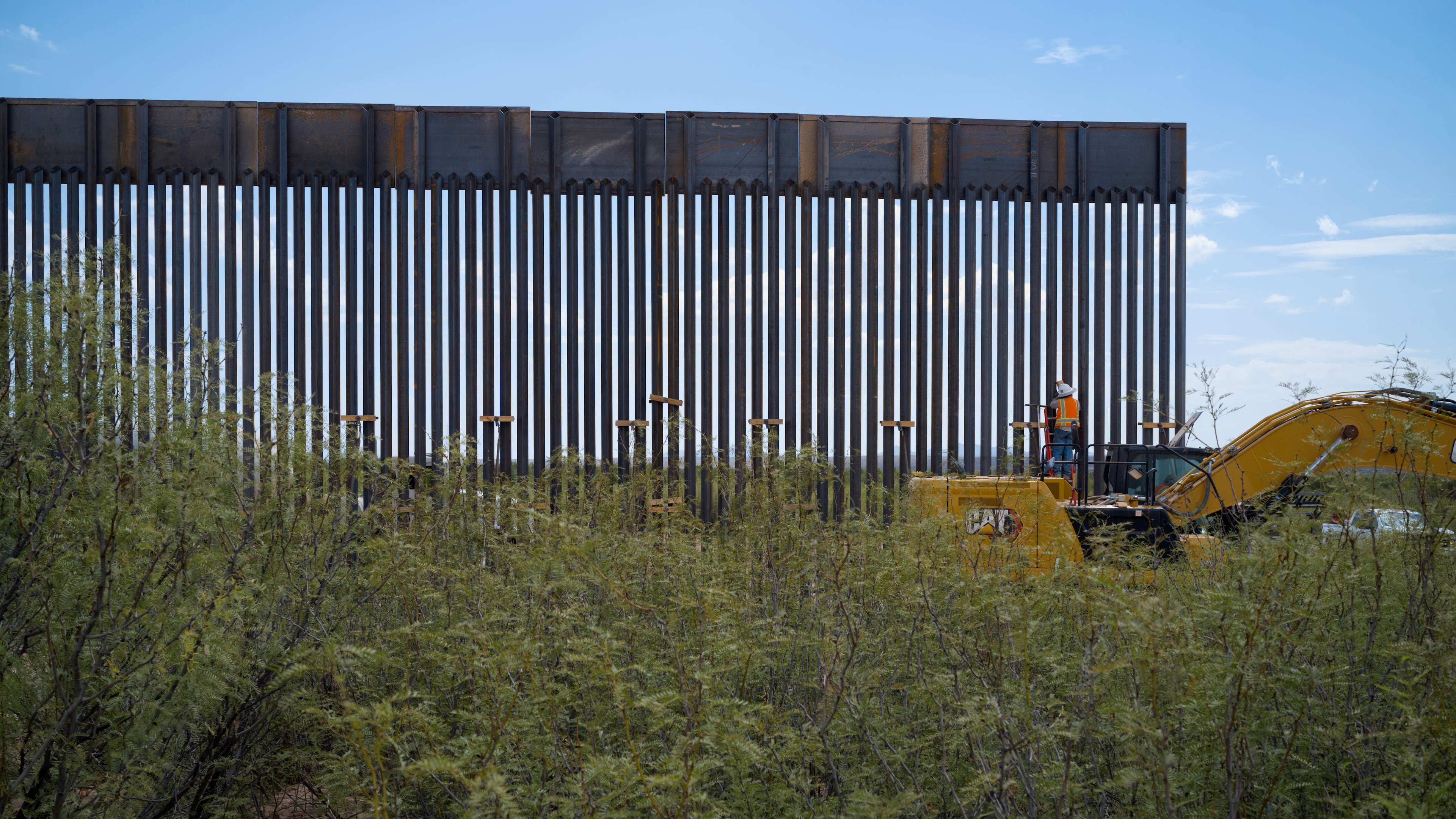 In this photo provided by Scott McWilliams, crews install the first sections of a new border wall in the Big Bend region of west Texas, on Sept. 16, 2026. (Scott McWilliams via AP)