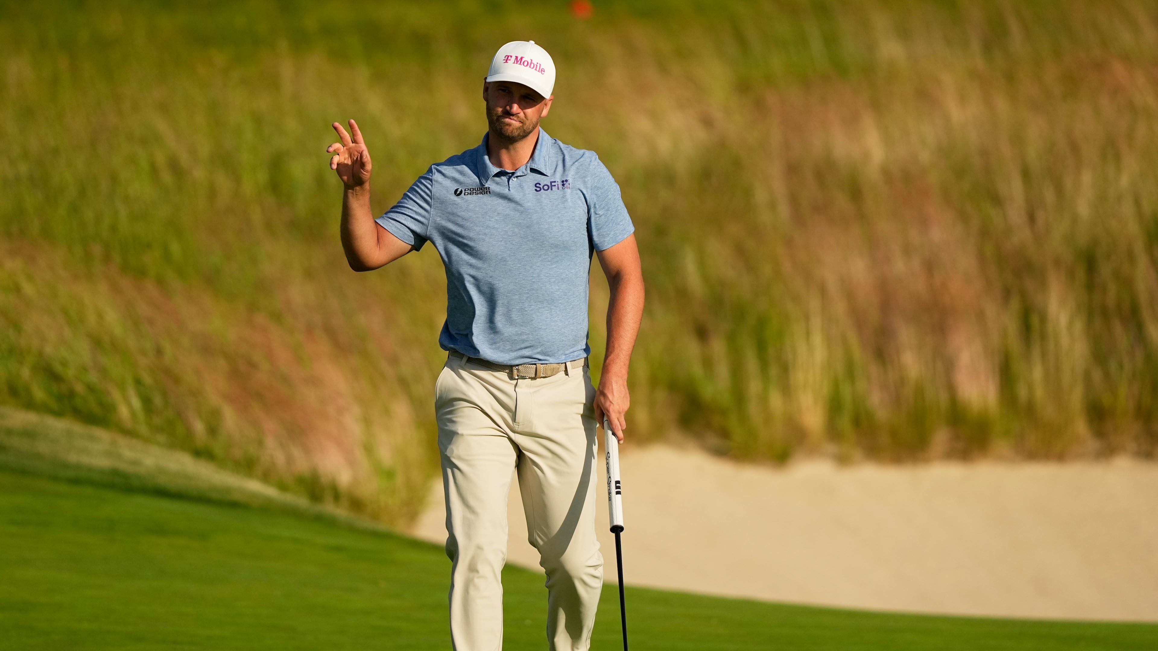 Wyndham Clark waves after his putt on the 18th hole during the first round of the U.S. Open golf tournament at Shinnecock Hills Golf Club in Southampton, N.Y., Thursday, June 18, 2026.(AP Photo/Gerald Herbert)