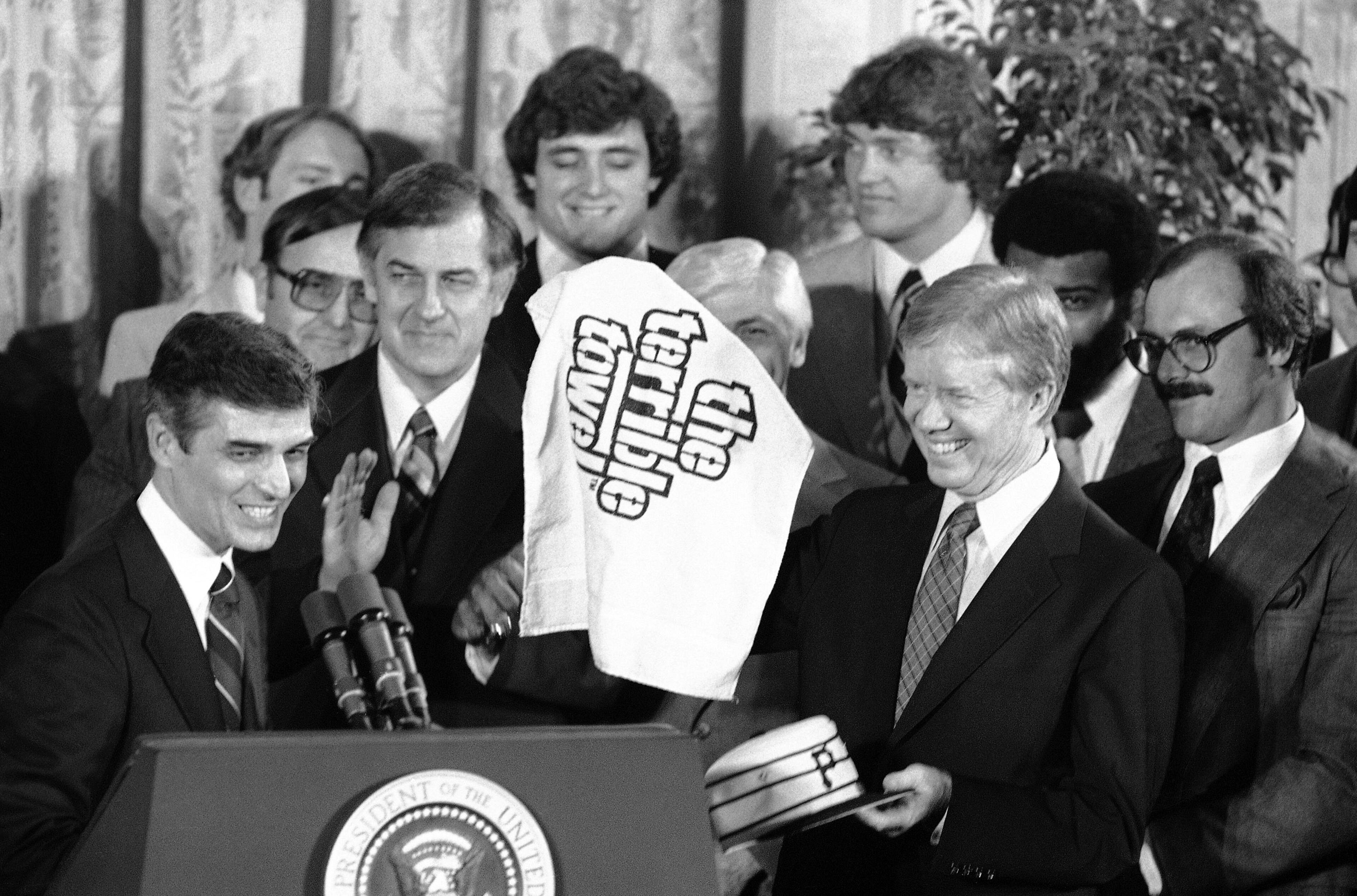 President Jimmy Carter holds a Pittsburgh Pirates cap and a Pittsburgh Steelers âterrible towelâ as he meets both champion teams at the White House in Washington on Feb. 22, 1980. The towel is a good luck symbol for the Steelers. At right is Steelersâ running back Becky Bleier. (Harvey Georges / AP file)