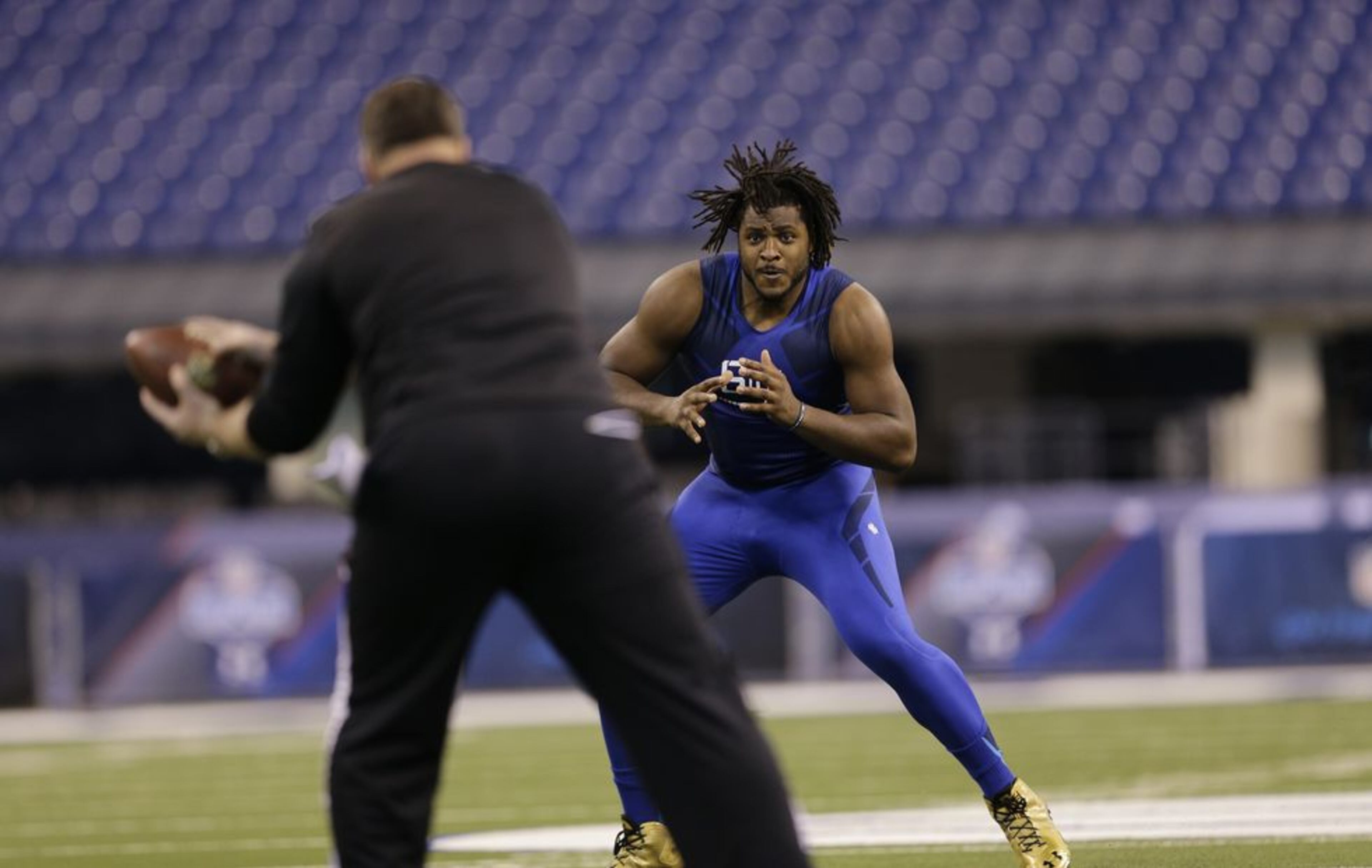 Pittsburgh offensive lineman T.J. Clemmings runs a drill at the NFL football scouting combine in Indianapolis, Friday, Feb. 20, 2015. (AP Photo/David J. Phillip)