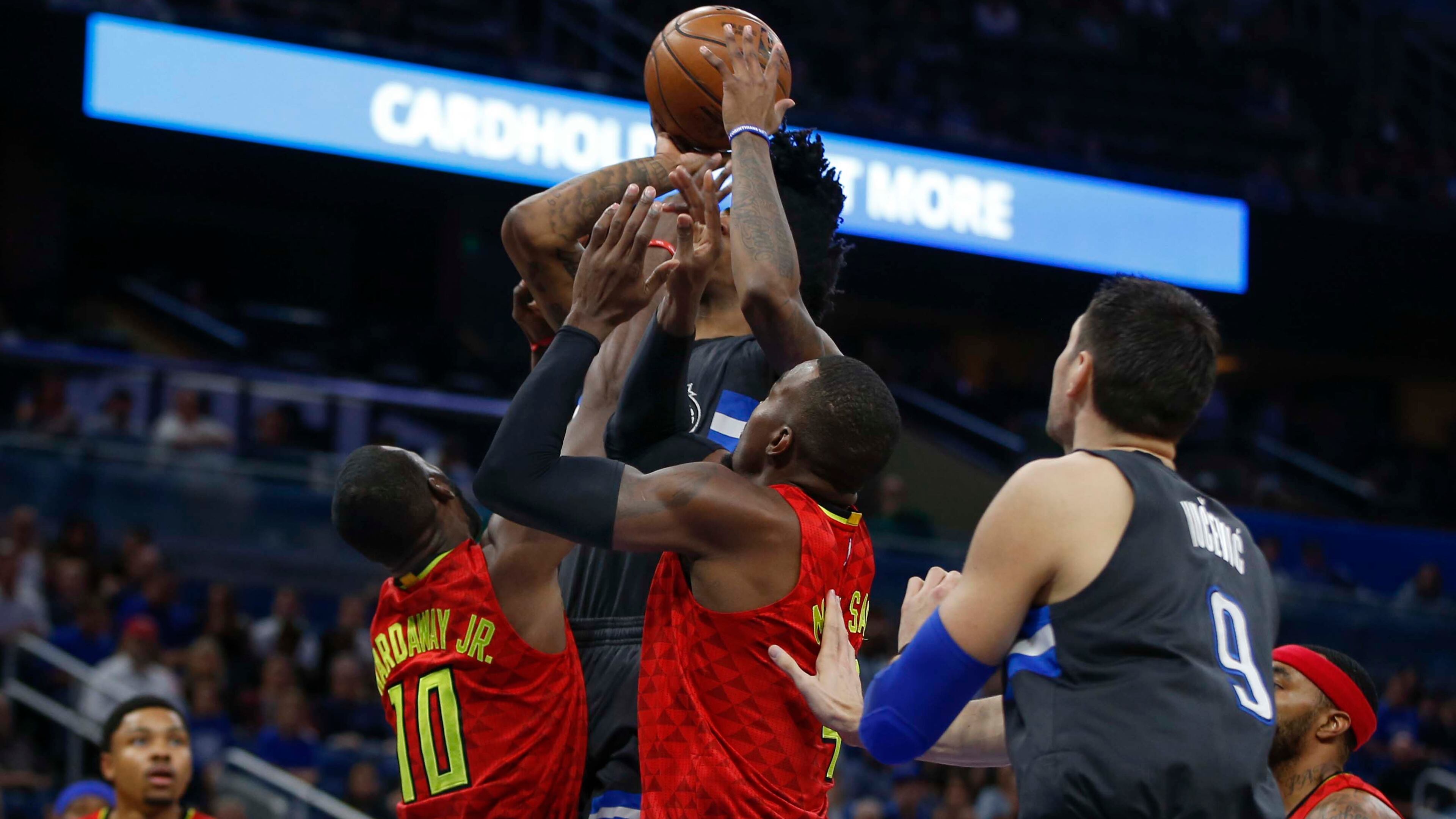 Atlanta Hawks forward Paul Millsap (4) and guard Tim Hardaway Jr. (10) get in there face of Orlando Magic guard Elfrid Payton (4) as Magic center Nikola Vucevic (9) looks on during the first quarter of an NBA basketball game in Orlando, Fla., on Saturday, Feb. 25, 2017. (AP Photo/Reinhold Matay)