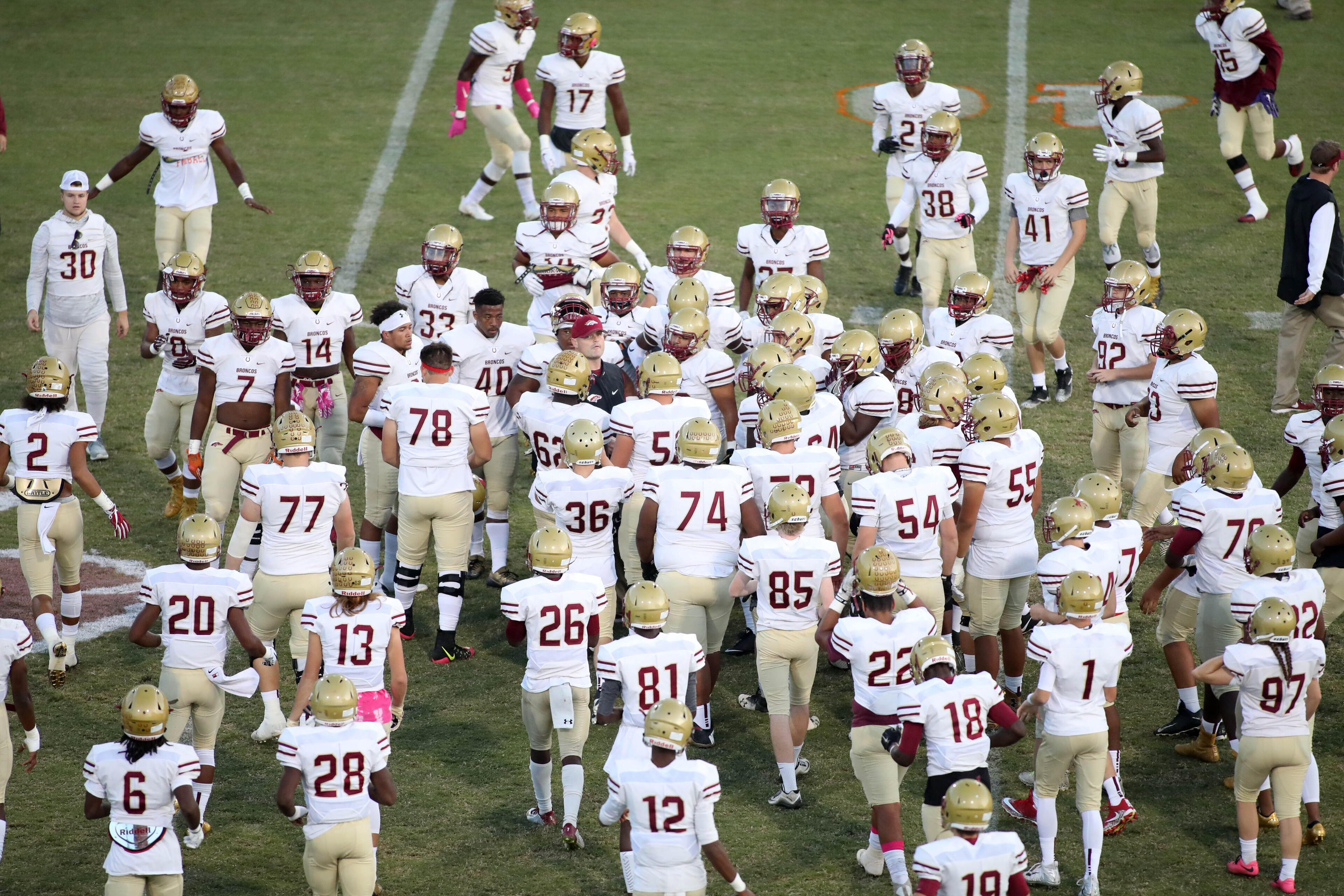 October 20, 2017 - Lilburn, Ga: Brookwood head coach Philip Jones, center, talks with players before their game against Parkview at Parkview High School Friday, October 20, 2017, in Lilburn, Ga.. PHOTO / JASON GETZ