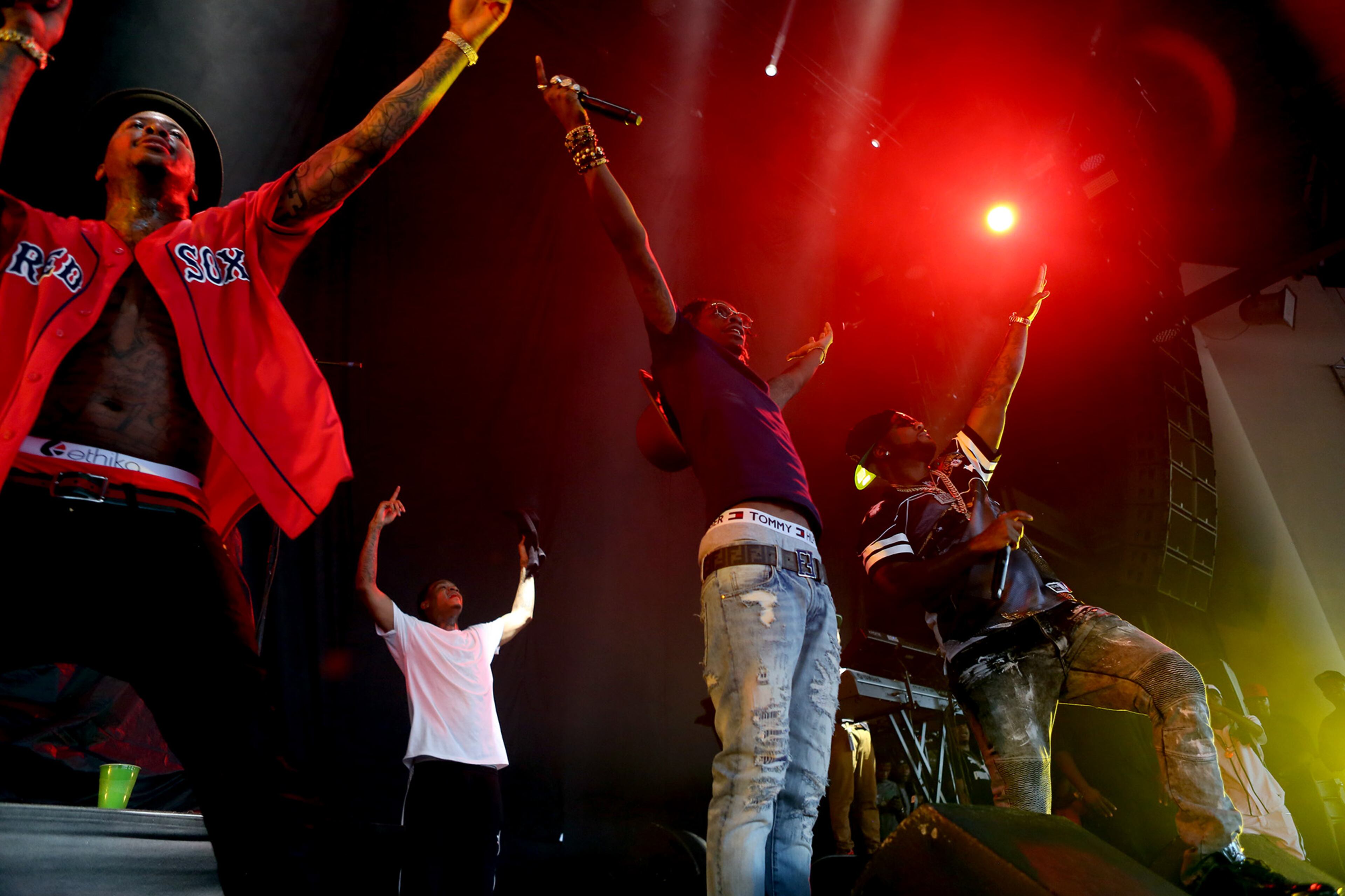 ATLANTA - West Coast rapper YG (Young Gangsta) from Compton, California, appears on tour as special guest and opening act for J. Cole and his "Forest Hills Drive Tour", at Aaron's Amphitheatre at Lakewood on Saturday, Aug. 15, 2015 in Atlanta. YG sprung a surprise of his own with special guests Rich Homie Quan, (center) and Young Jeezy performing with him near the end of his set. (Akili-Casundria Ramsess/Special to the AJC)