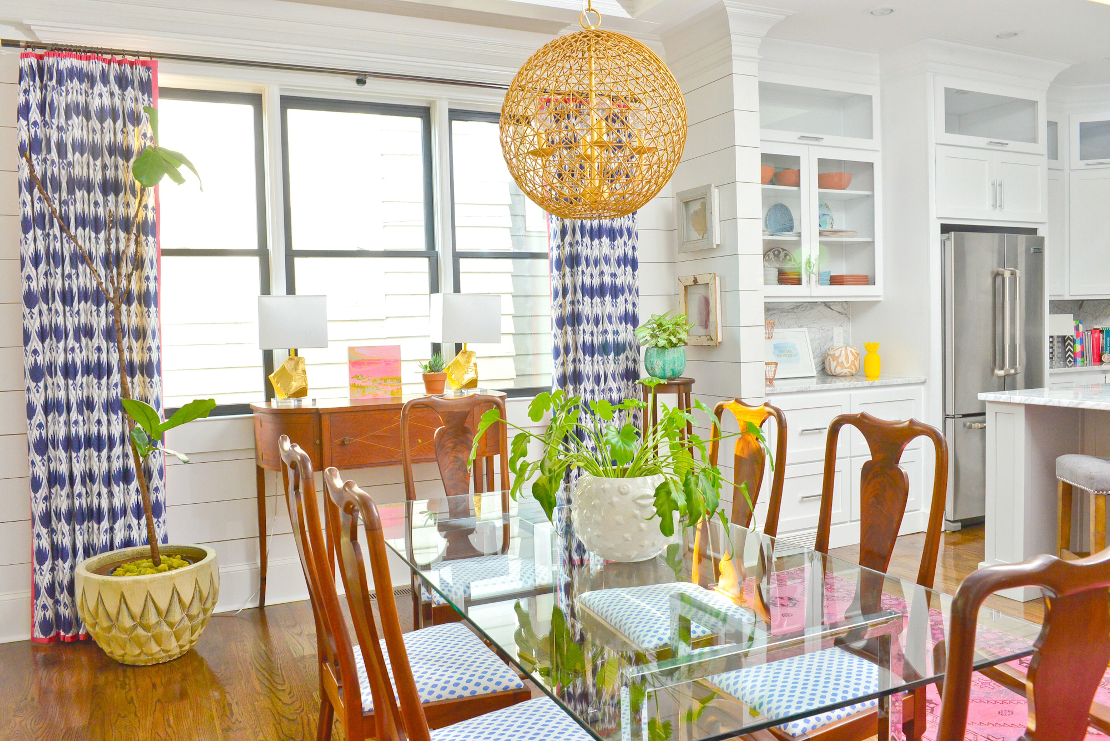 White received her dining room table and chairs as a gift from her parents, who purchased them in the 1960s. She had the chairs recovered in a blue-and-white pattern to complement the deep blue in the curtains and to fit the laid-back coastal decor in other parts of the home.