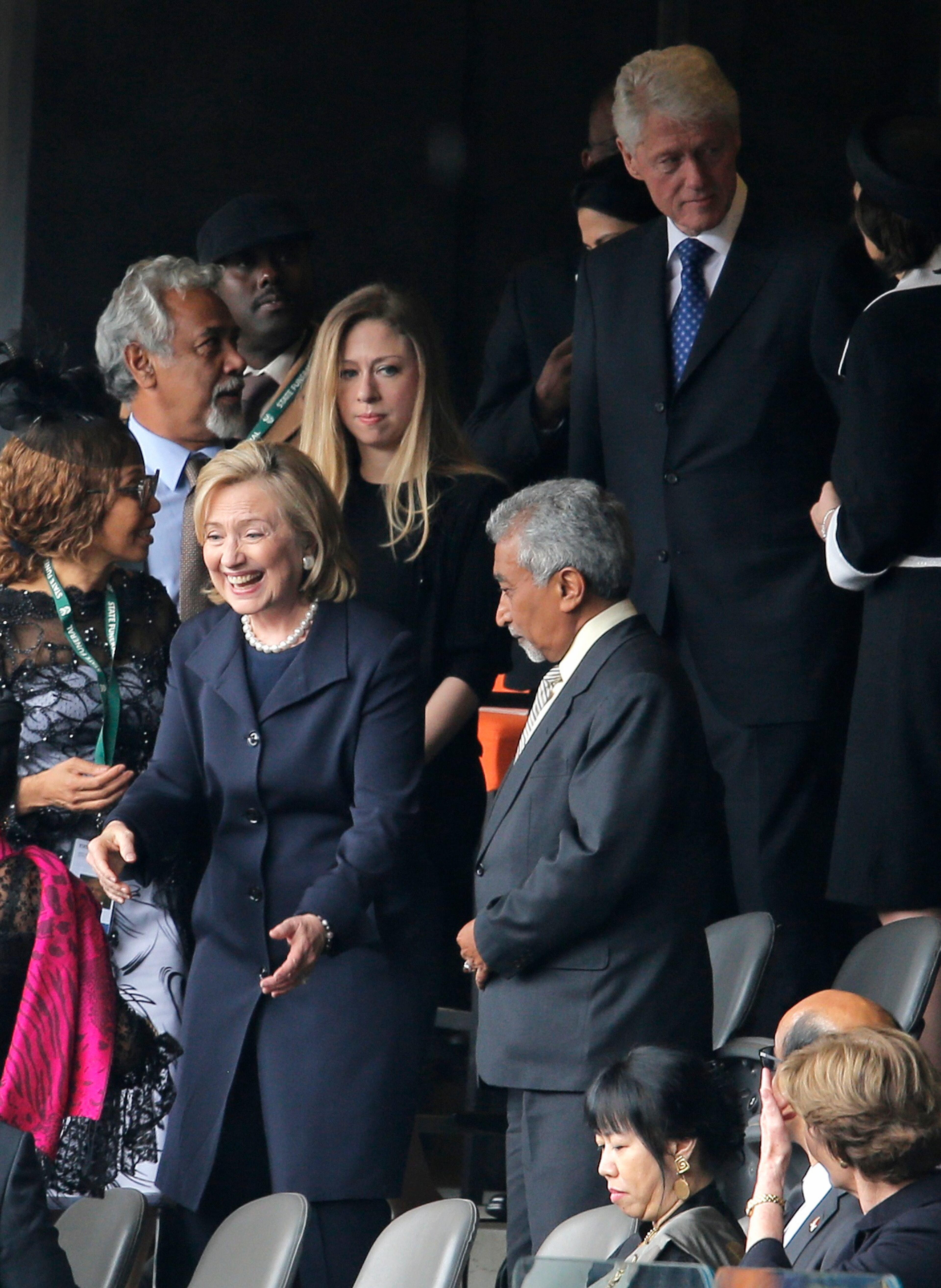 Former U.S. Secretary of State Hillary Rodham Clinton, former U.S. President Bill Clinton and their daughter Chelsea arrive for the memorial service for former South African president Nelson Mandela at the FNB Stadium in Soweto, near Johannesburg, South Africa, Tuesday Dec. 10, 2013. (AP Photo/Peter Dejong)