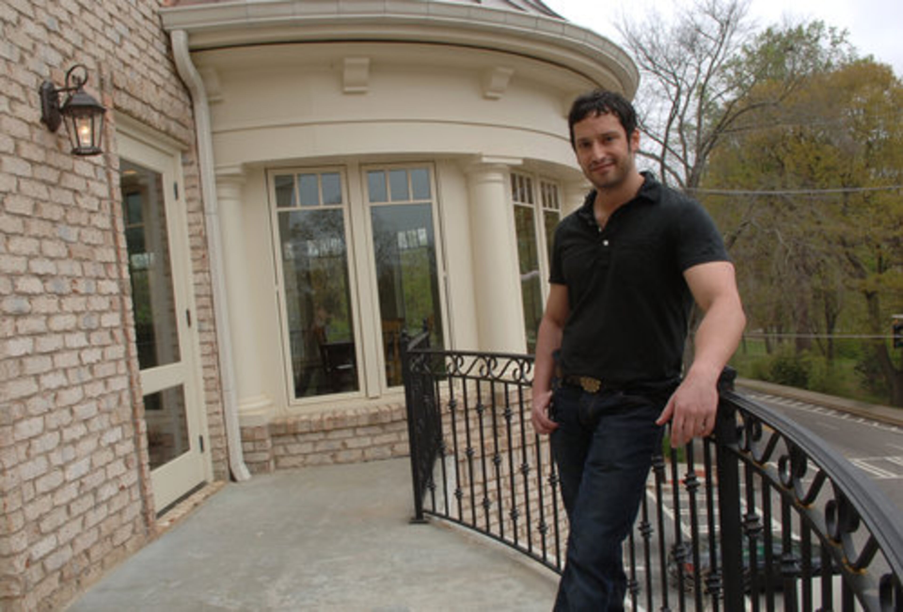 On low-traffic days, Kansas can hear the Zoo Atlanta lions roar from the front balcony that runs the length of his living room.