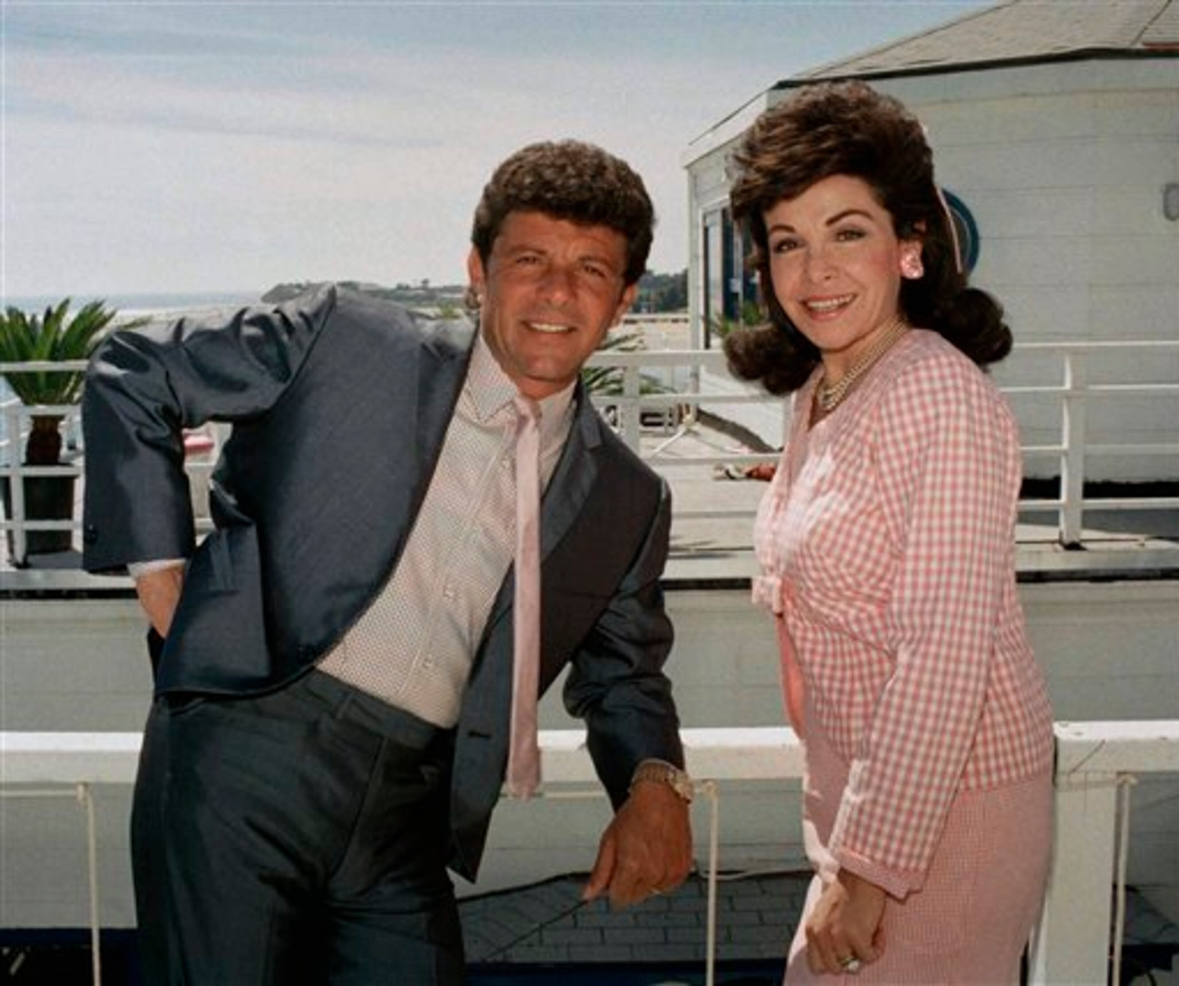Frankie Avalon and Annette Funicello, who starred in ?Beach Blanket Bingo,? ?How to Stuff a Wild Bikini? and other memorable movies of the mid-Sixties, relax during break in taping of their new movie ?Back to the Beach? in Malibu, Calif., April 13, 1987. They play onetime beach lovers who move to Ohio. (AP Photo/Bob Galbraith)