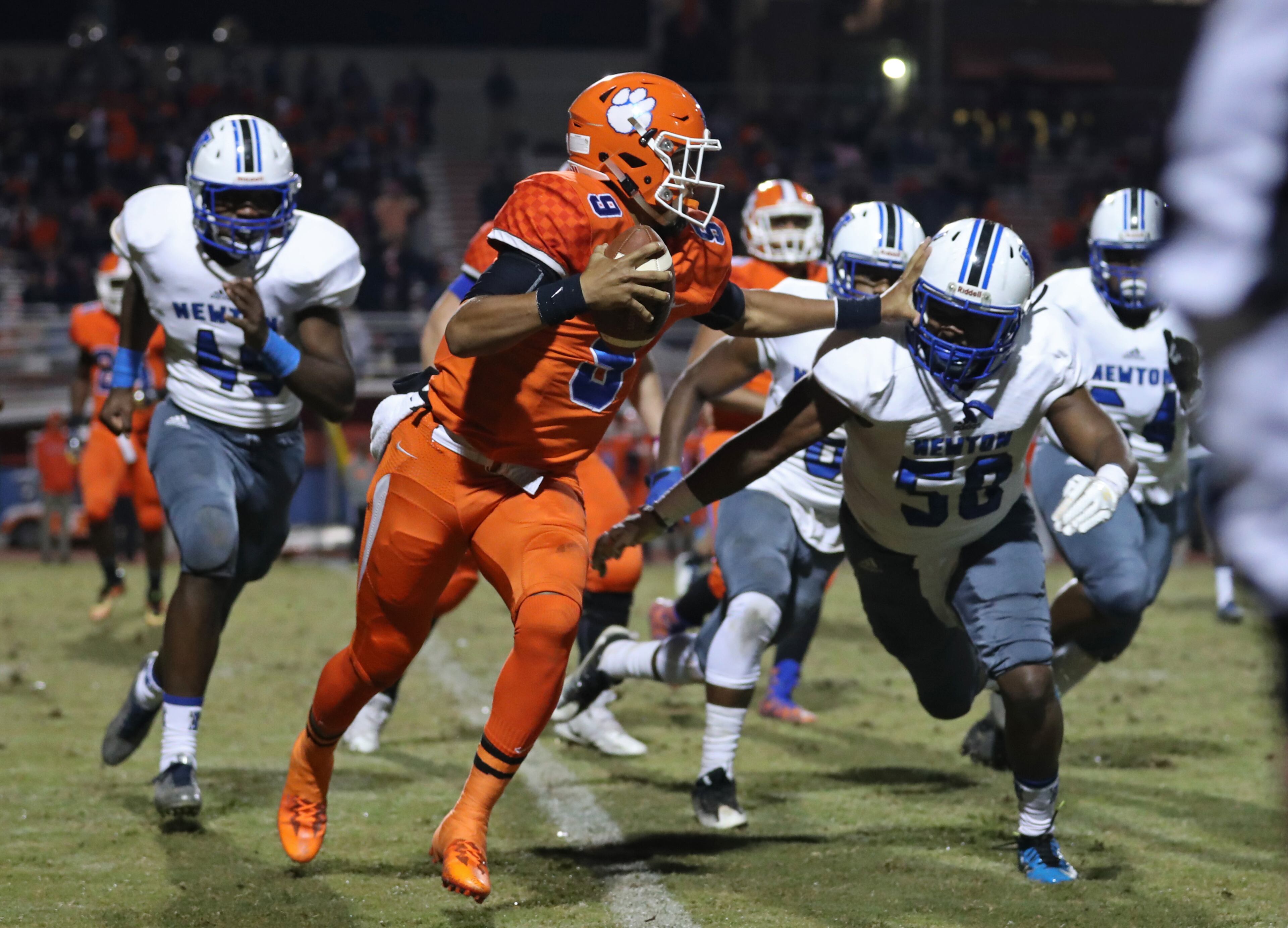 Parkview quarterback Fred Payton (9) runs against Newton defensive lineman Brandon Green (58) in the first half of their game in the first round of the Class AAAAAAA playoffs at Parkview High School Friday, November 10, 2017, in Lilburn, Ga. PHOTO / JASON GETZ