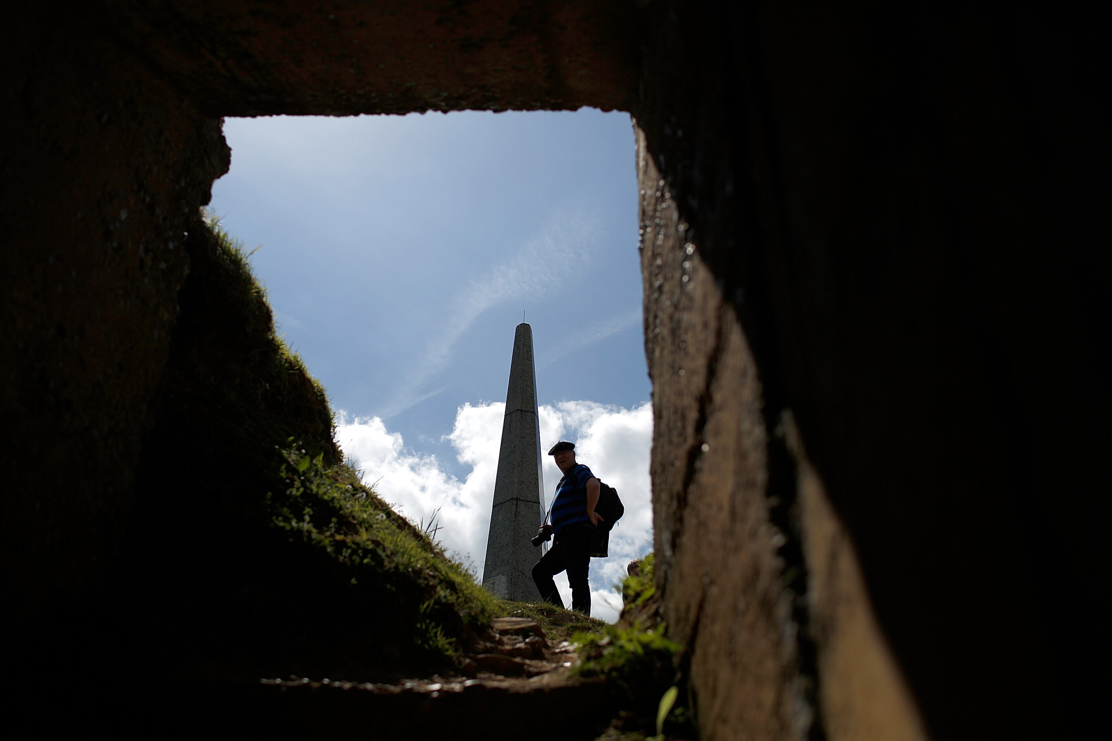 A vsitor pays his respects at the First Infantry Division memorial, adjacent to a former German concrete bunker, above Omaha Beach on the eve of the 70th anniversary of D-Day June 5, 2014 in Colleville-sur-Mer, France.
