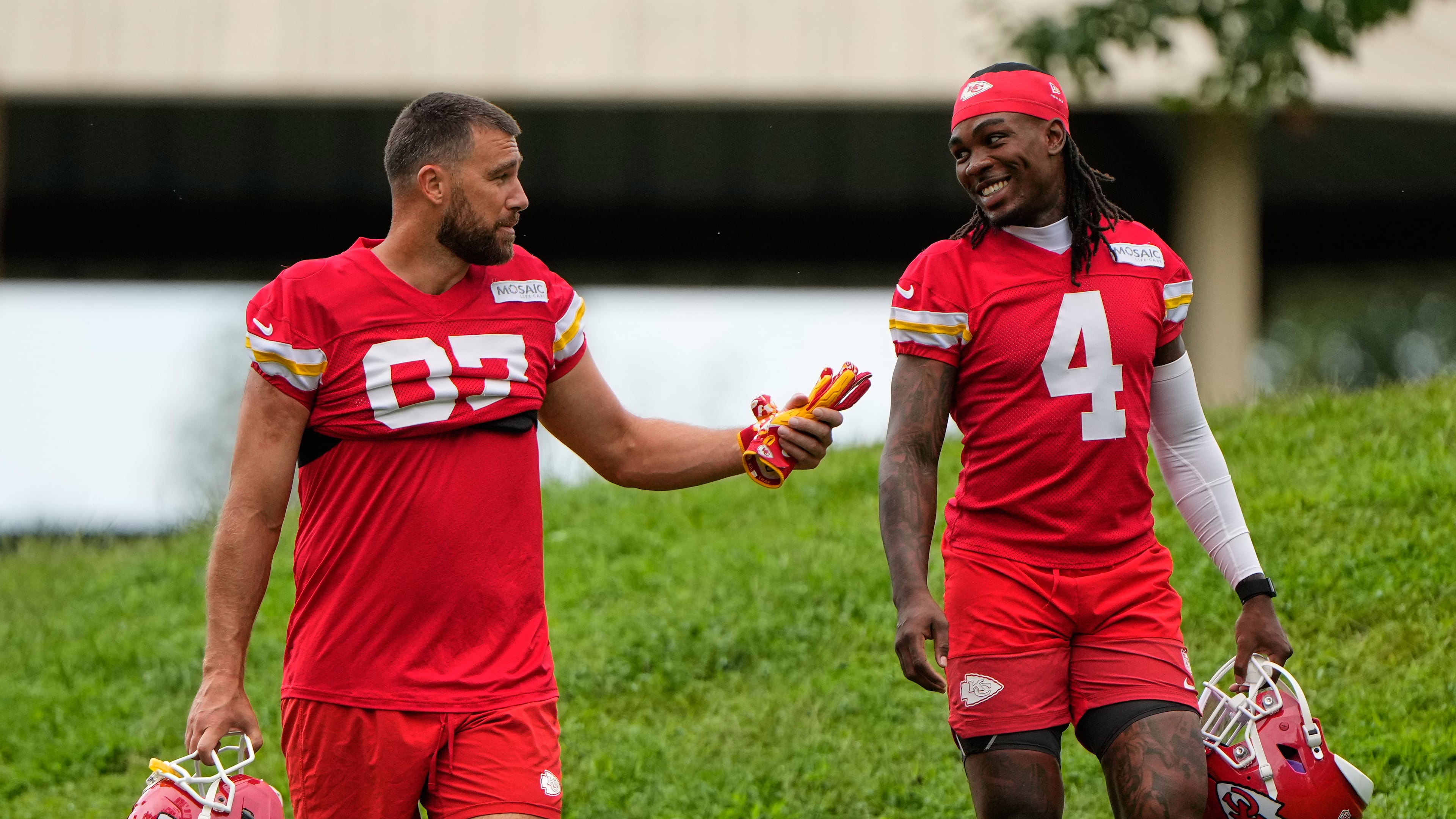 Kansas City Chiefs tight end Travis Kelce (87), and wide receiver Rashee Rice (4) walk to NFL football training camp Friday, July 31, 2026, in St. Joseph, Mo. (AP Photo/Charlie Riedel)