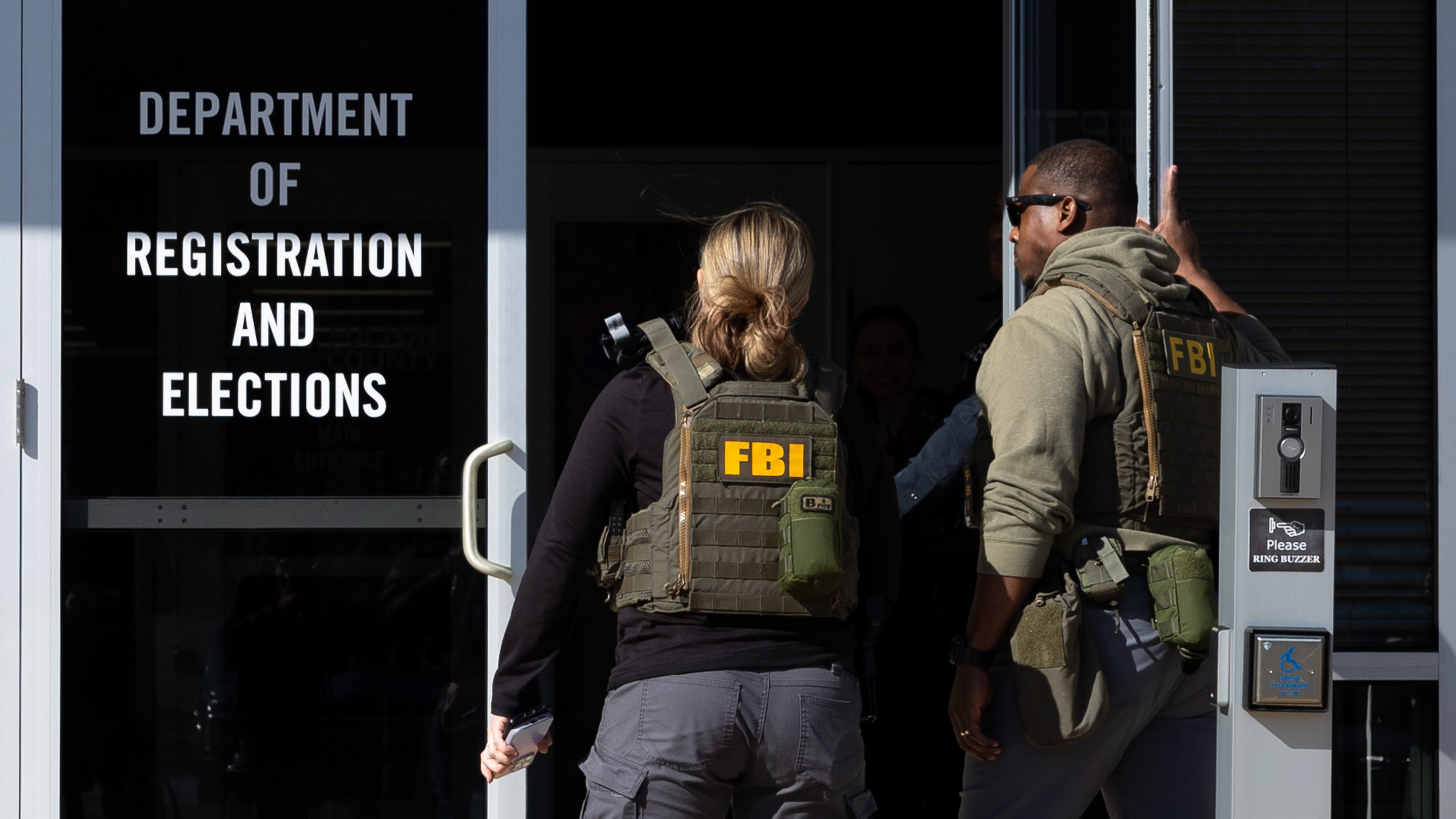 FBI agents enter the Fulton County Election Hub and Operation Center in Union City on Wednesday, Jan. 28, 2026, as the FBI conducts a raid. (Arvin Temkar/AJC)