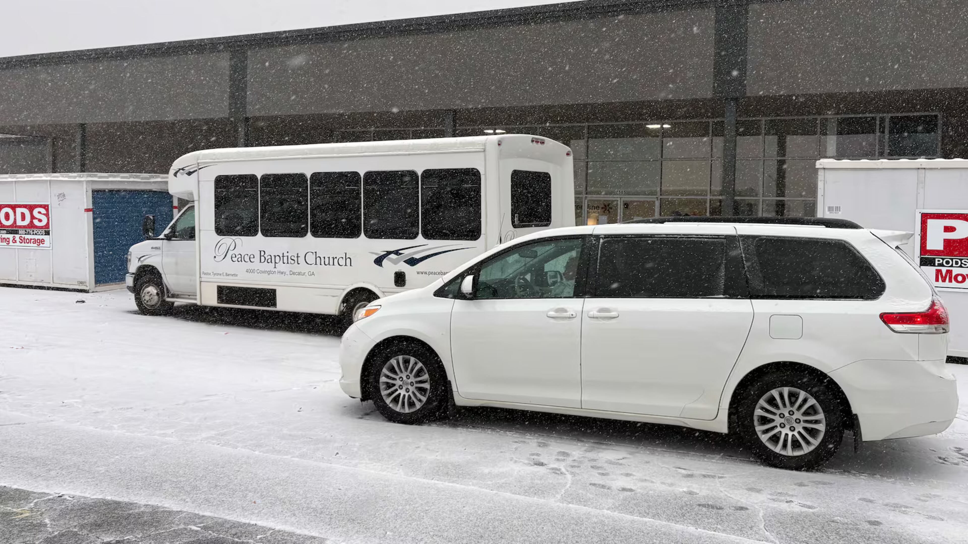 A van and a bus idle in front of Frontline Response International, one of the warming shelters run by DeKalb County, Georgia, on Tuesday, January 21, 2025. The county was transporting residents in need of shelter. (Photo Courtesy of Allen Siegler / Healthbeat)