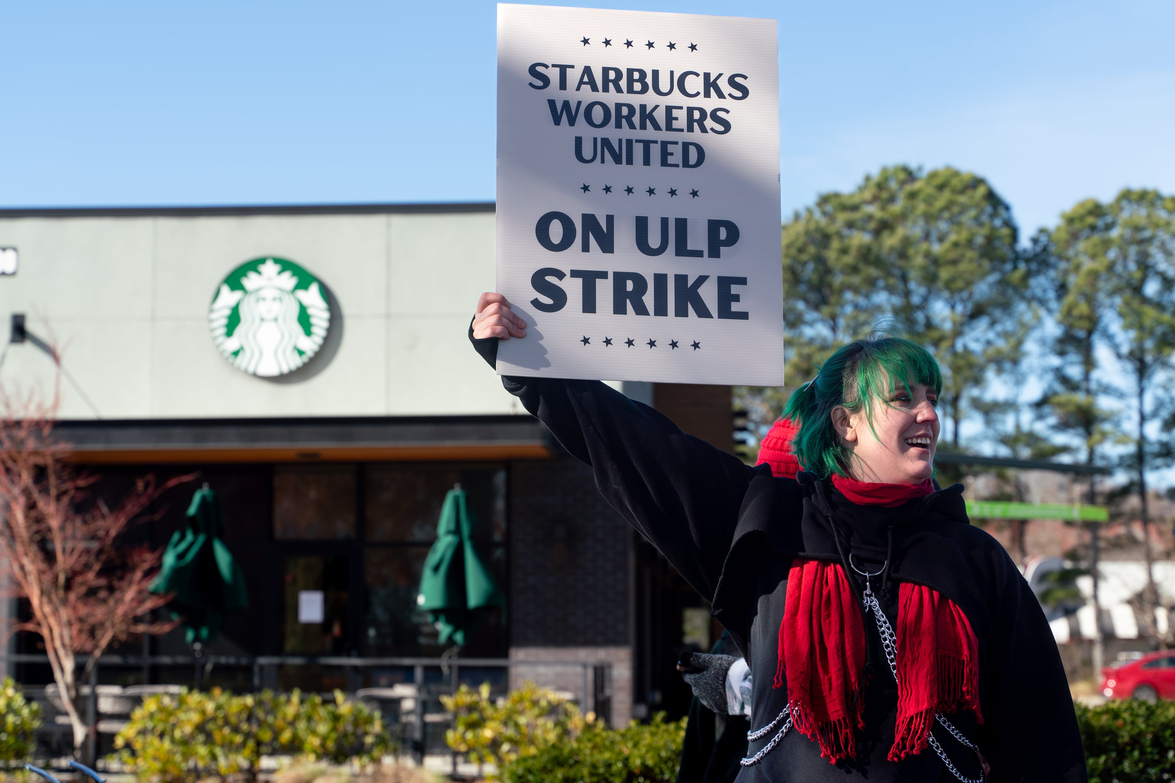 Cory Stepping, a barista, protests outside the Starbucks on Haynes Bridge Road in Alpharetta on Tuesday. (Ben Hendren for the AJC)