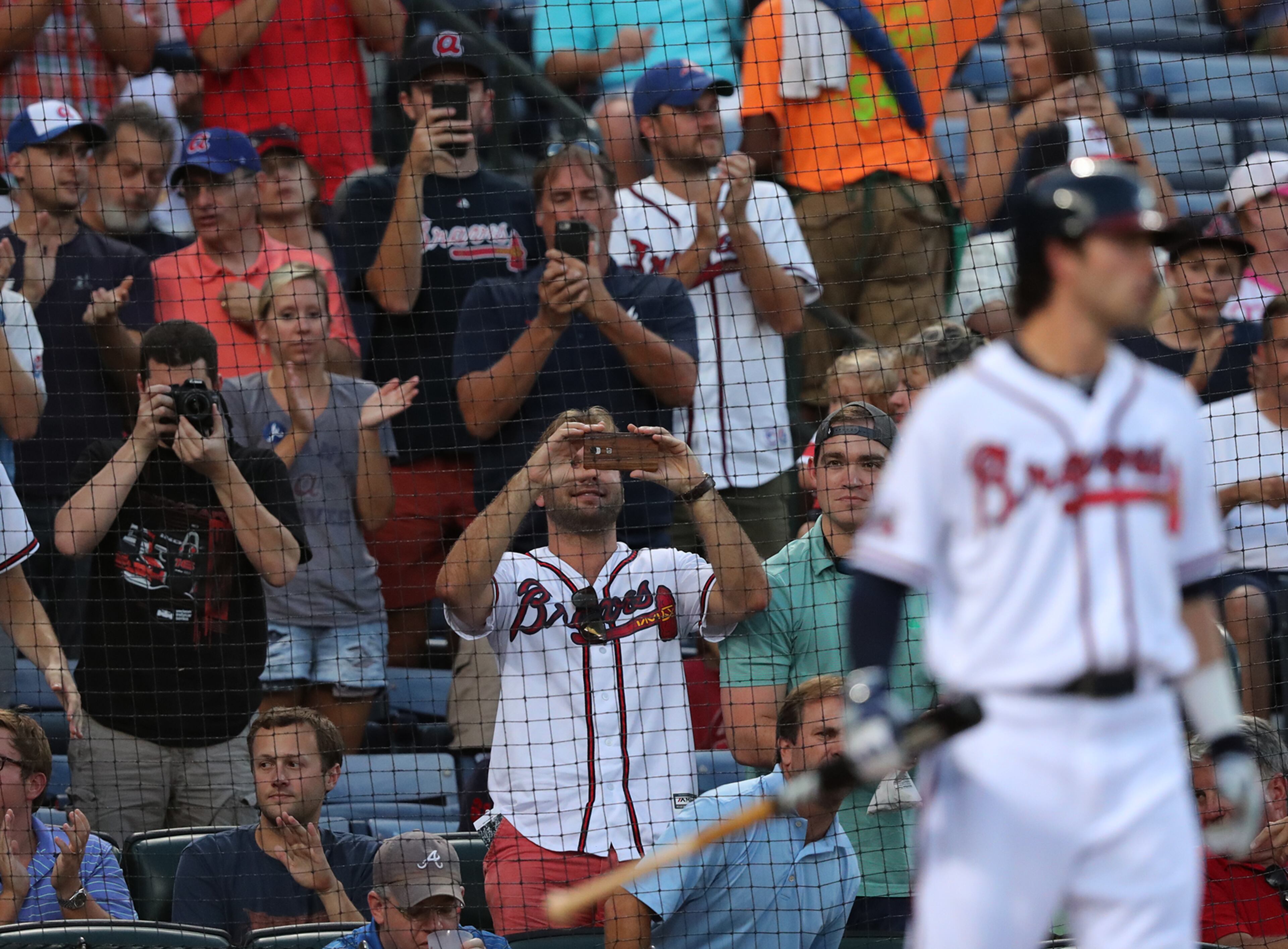 Fans snap photos and cheer as Braves Dansby Swanson makes his first MLB plate appearance flying out to the Twins during the second inning in a MLB baseball game on Wednesday, August 17, 2016, in Atlanta. Curtis Compton /ccompton@ajc.com