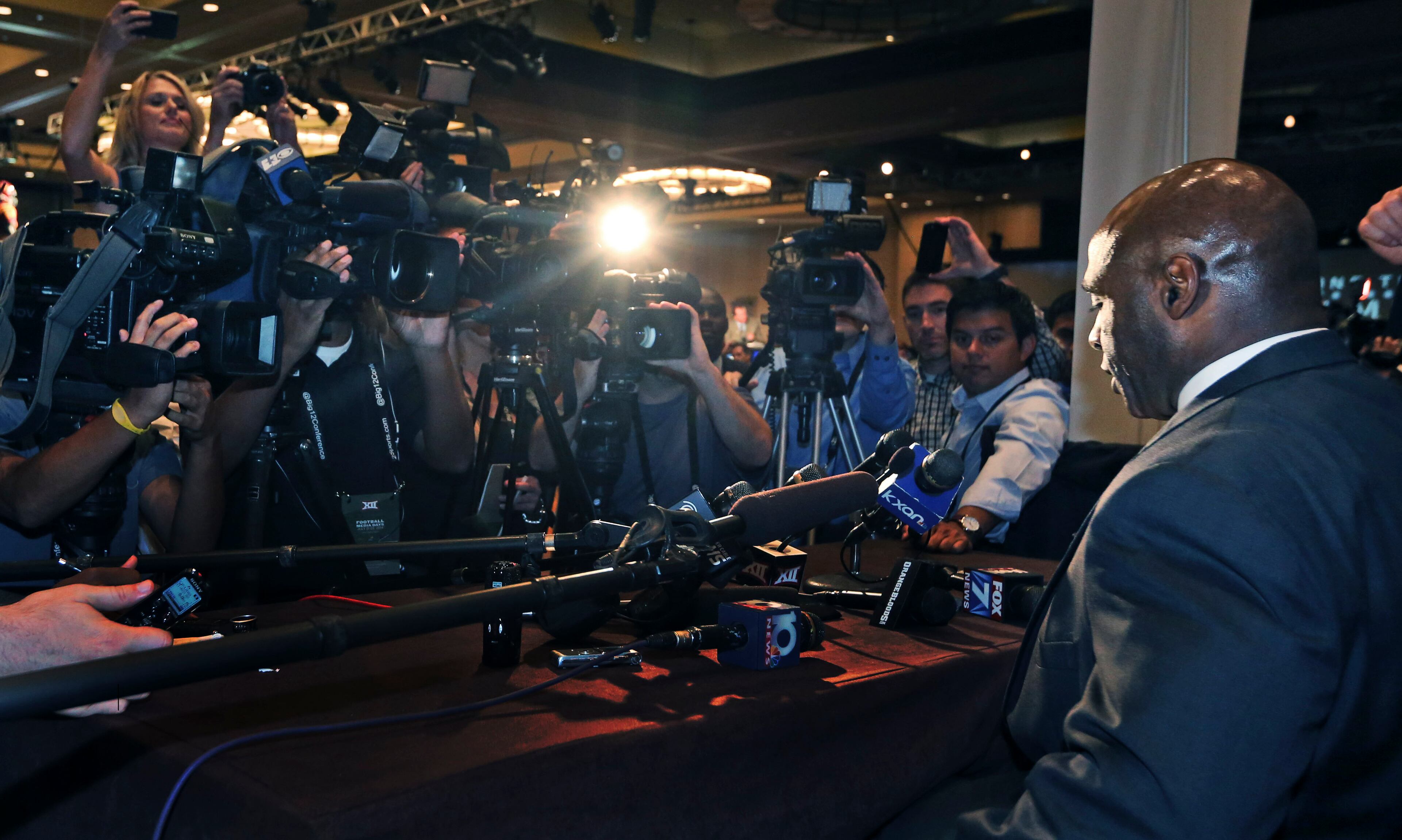 Media crowd around Texas coach Charlie Strong during the NCAA college Big 12 Conference football media days in Dallas, Tuesday, July 22, 2014. (AP Photo)