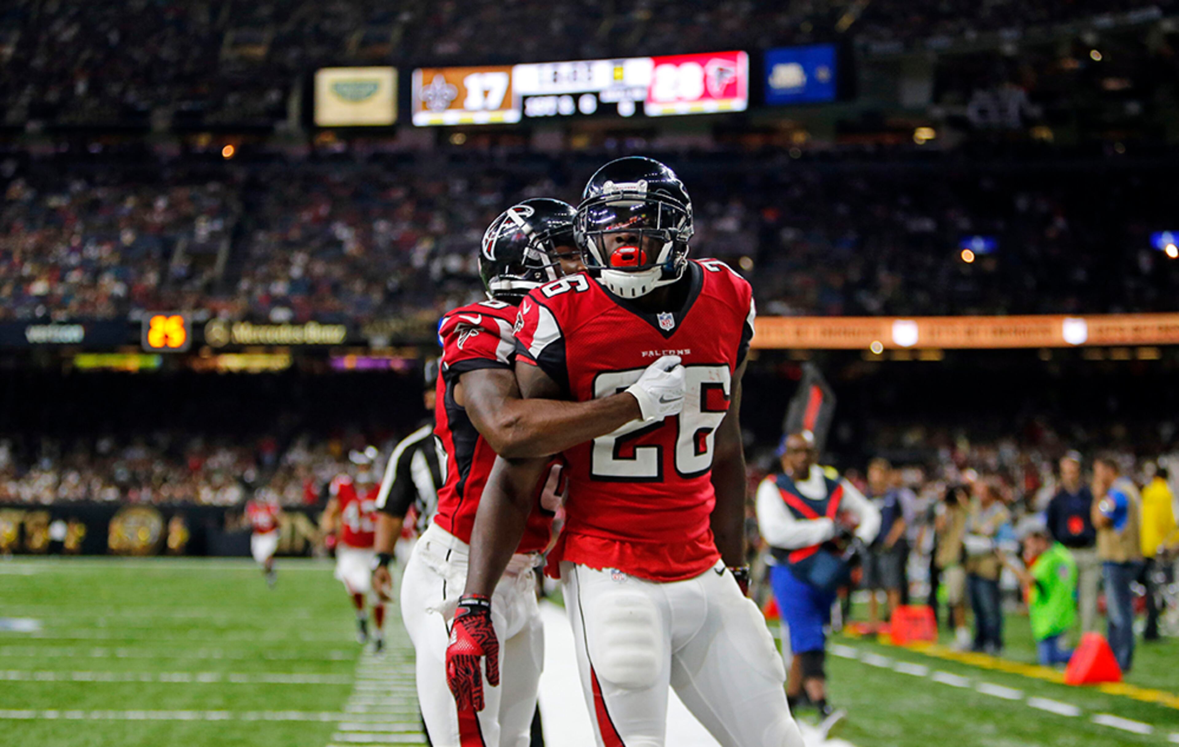 Atlanta Falcons running back Tevin Coleman (26) crosses into the end zone for a touchdown in front of New Orleans Saints free safety Vonn Bell (48) in the second half in New Orleans, Monday, Sept. 26, 2016.