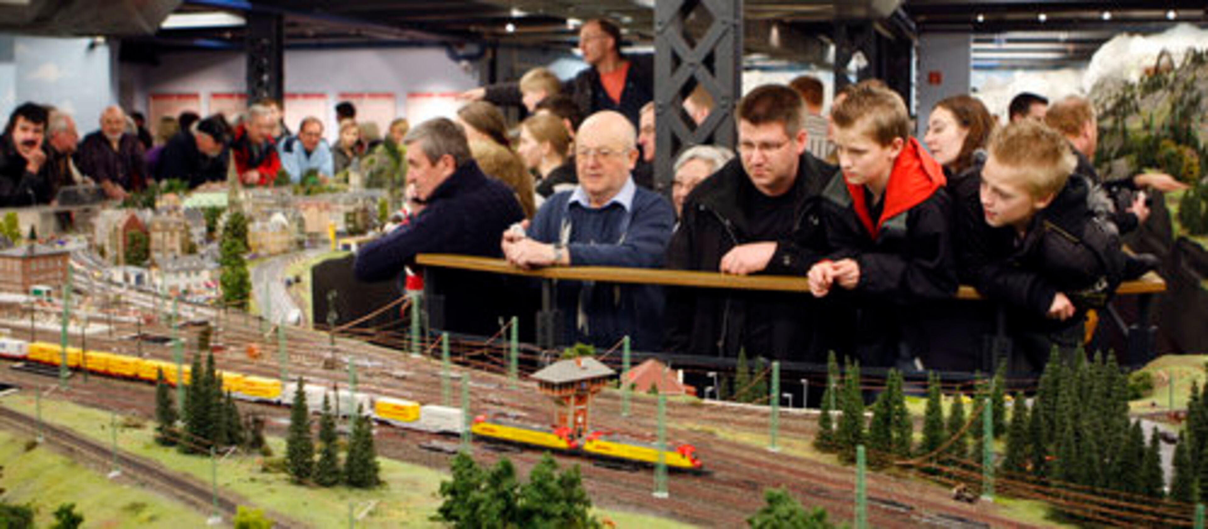 ONLOOKERS TAKE in a railroad scene. About 30 accidents involving derailed trains happen every day, and one of the museum's 180 employees has to make repairs.