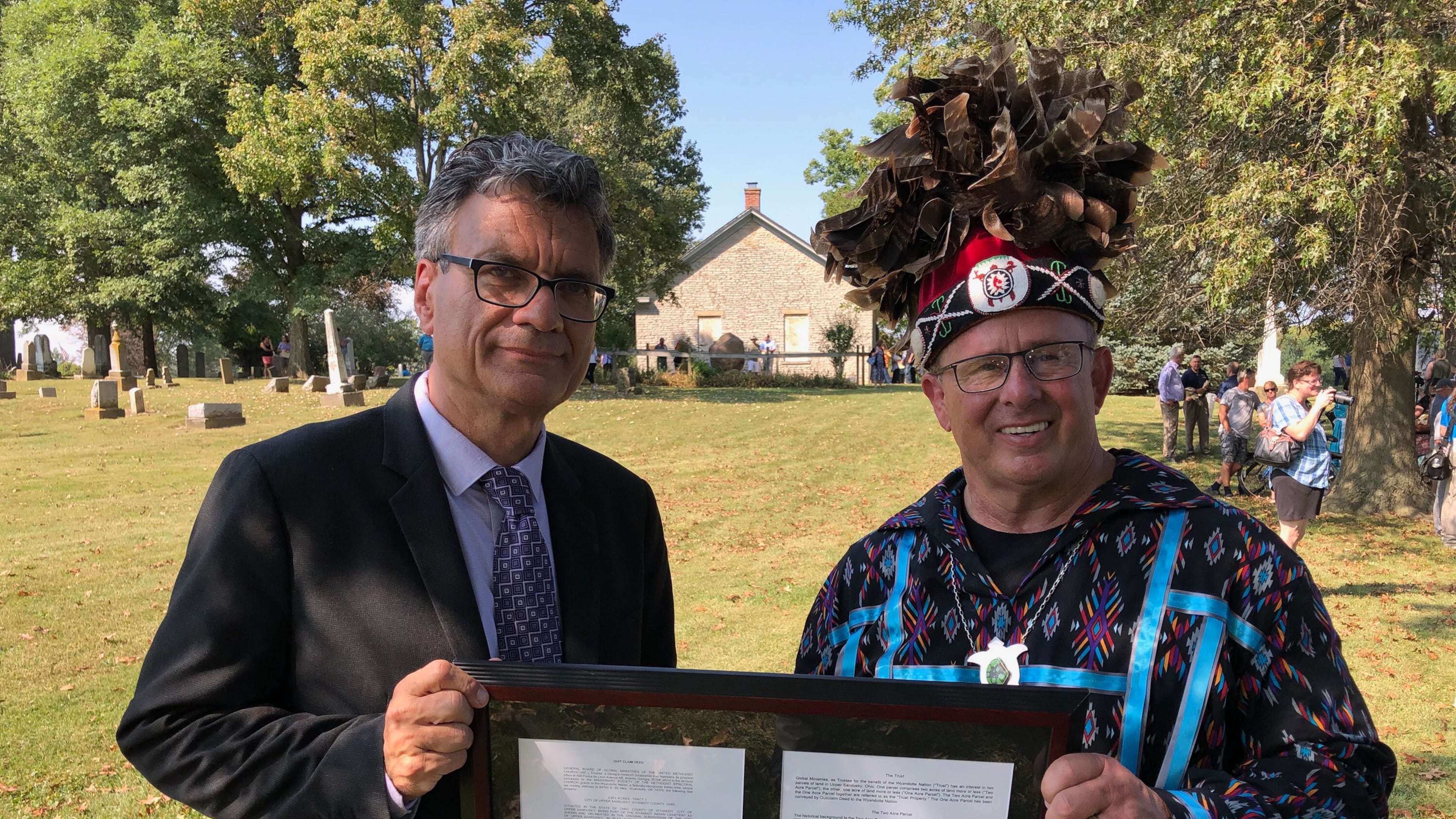 Thomas Kemper, general secretary of the UMC’s General Board of Global Ministries (left), and Billy Friend, chief of the Wyandotte Nation of Oklahoma, display a deed document during an event Saturday, September 21, 2019, marking the return of sacred land to the Native Americans. (Photo: United Methodist Church Global Ministries)