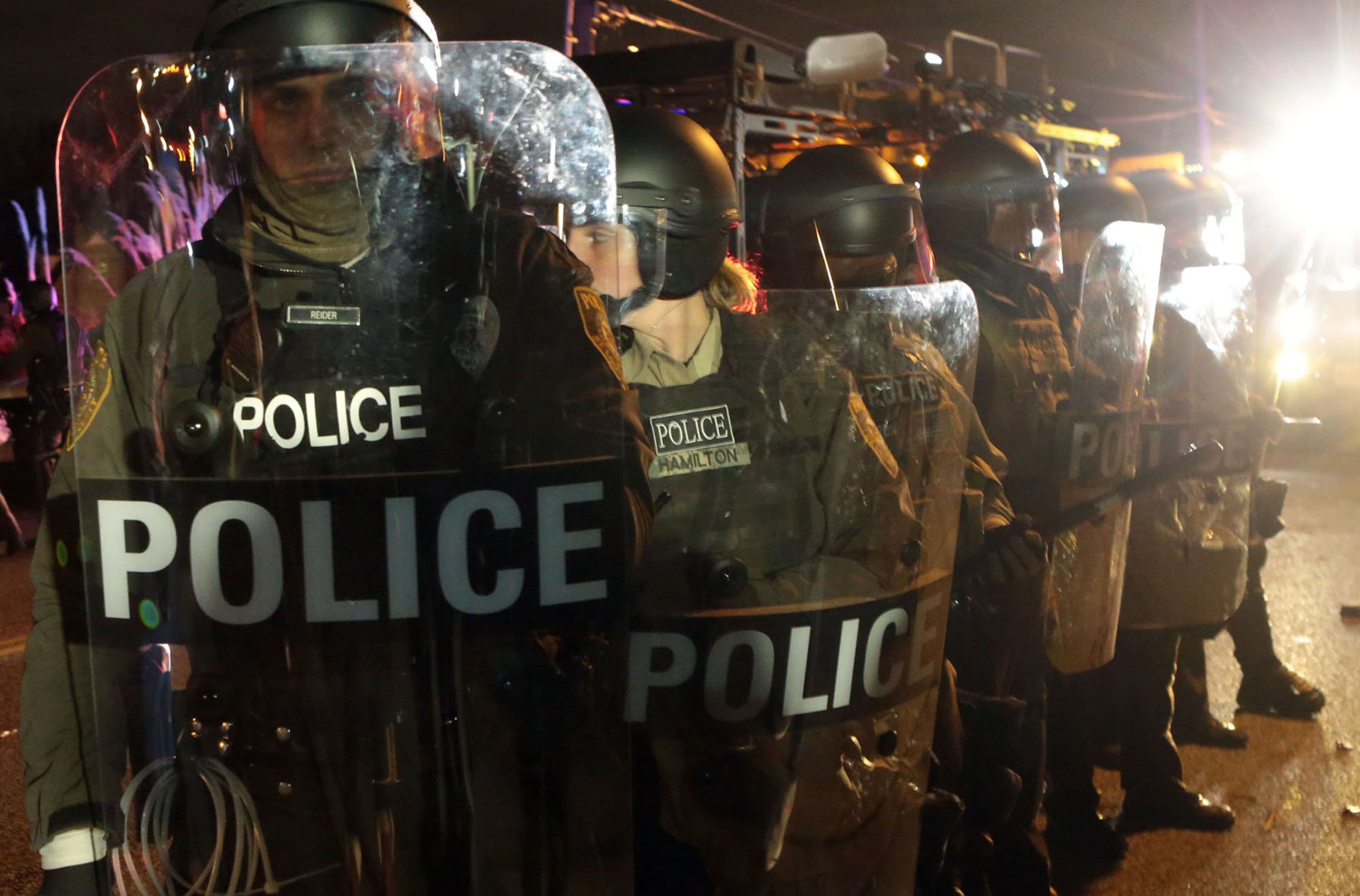 Police post in riot gear outside the Ferguson Police Station on S. Florissant Rd. on Monday, Nov. 24, 2014 in Ferguson, Mo. Protesters took the streets erupting in mass looting and confrontation with riot police throughout the night after the grand jury decision not to indict police officer officer Darren Wilson the death of Michael Brown. (AP Photo/The St. Louis Post-Dispatch, Laurie Skrivan)