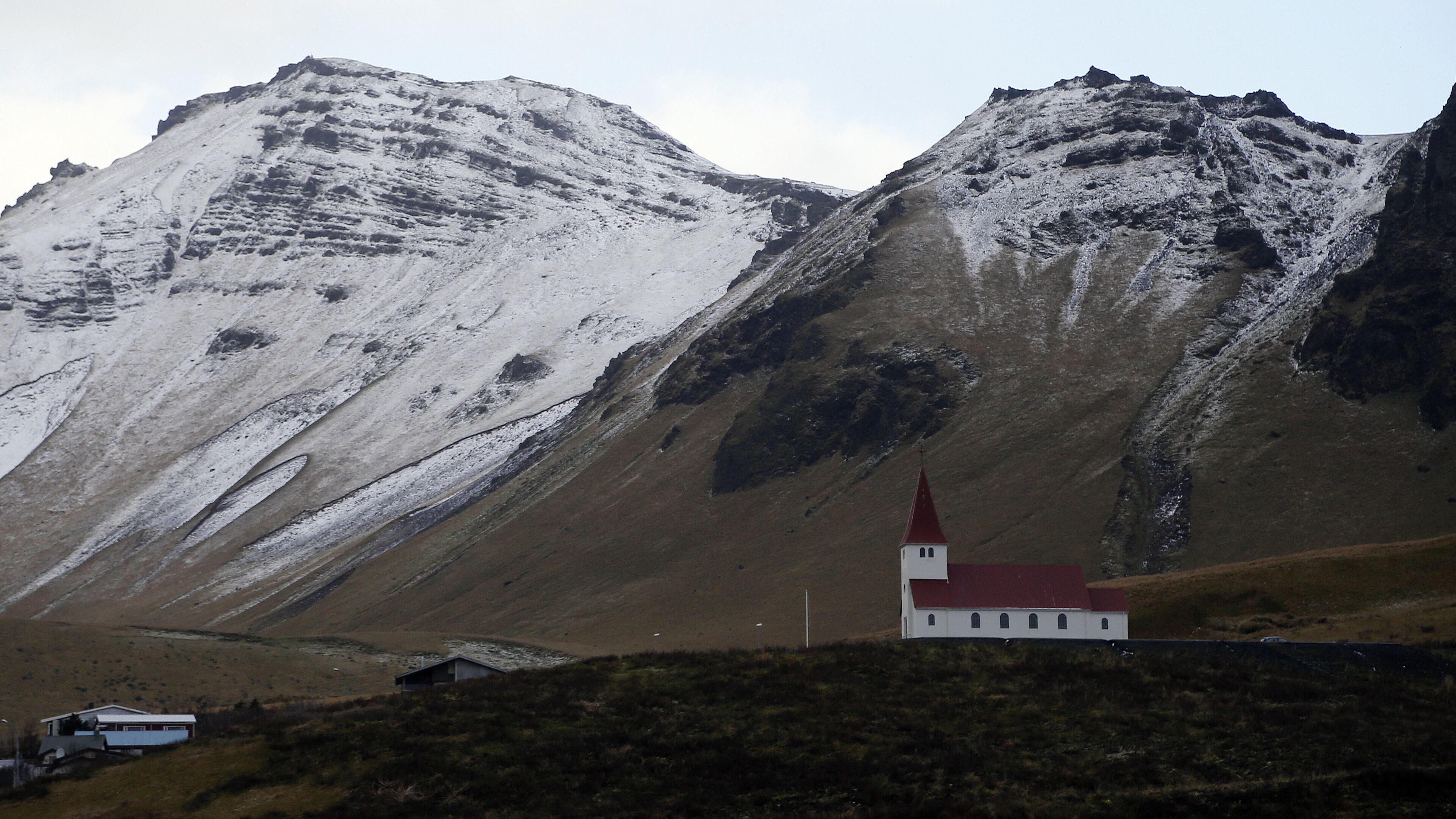 FILE - In this Oct. 26, 2016 file photo, the church of Vik, Iceland, near the Volcano Katla, After a summer of increased seismic activity at Katla, Icelanders are obsessing over the smallest sign of an eruption at the countryâs most closely watched volcano. Katla last erupted in 1918. Never before in recorded history, dating back to the 12th century, have 99 years passed without an eruption from the volcano. (AP Photo/Frank Augstein, File)