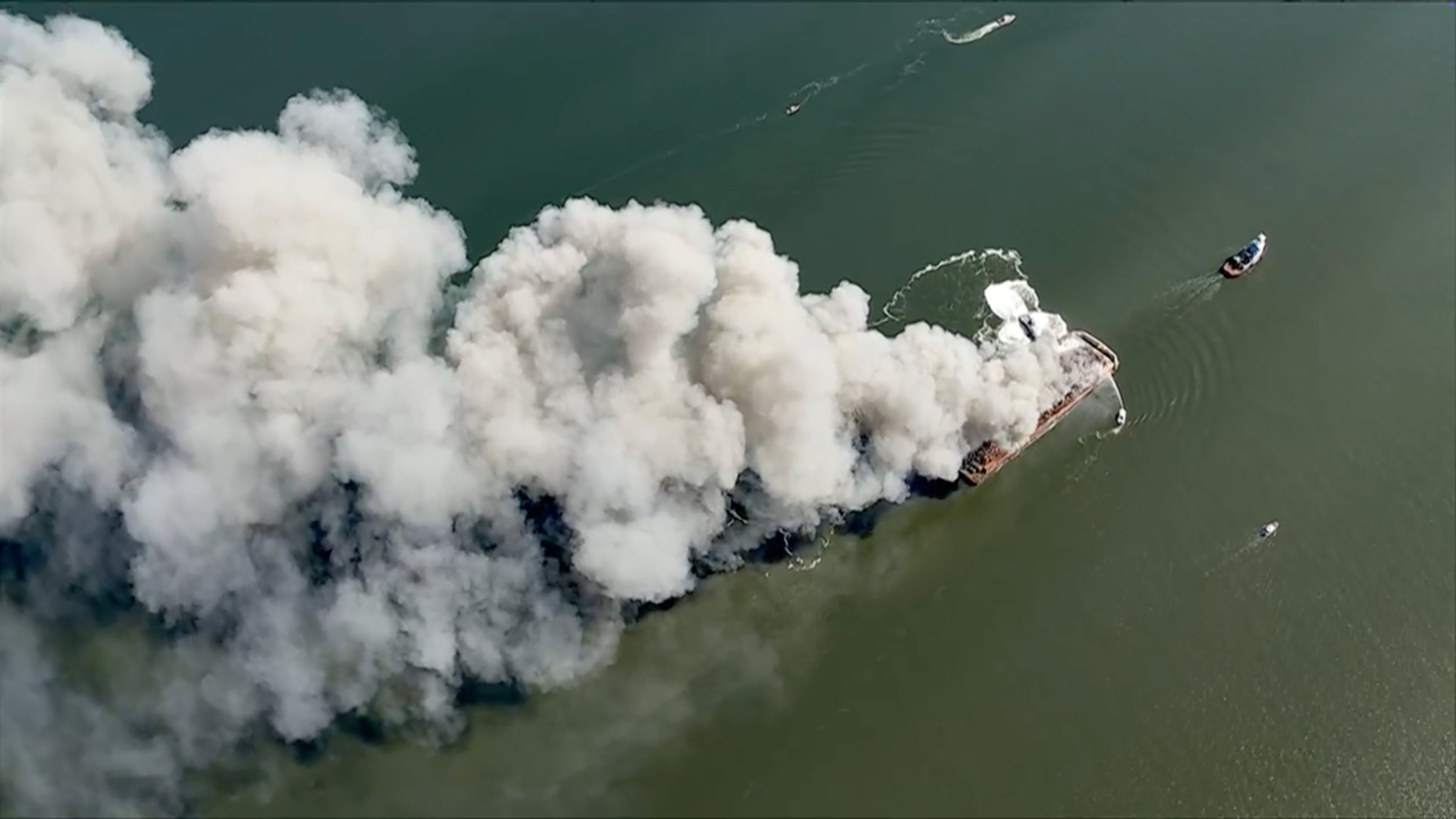 Smoke fills the sky as firefighters battle a massive blaze that erupted on a barge on the Delaware River on Tuesday, March 10, 2026 in New Castle, Del. (WPVI via AP)