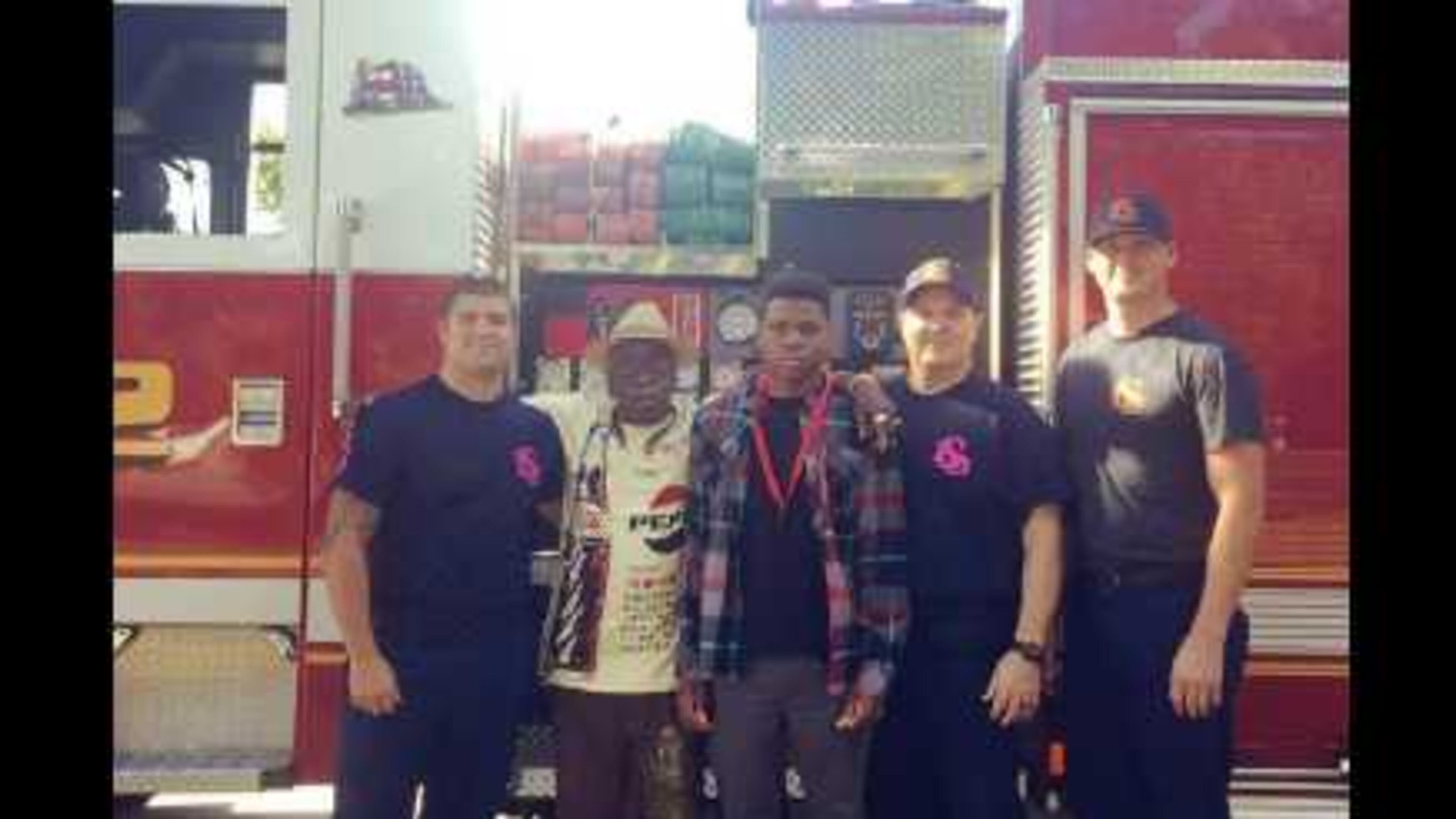 Lawrence Marzett III, who is in 10th grade at Campbell High School, poses with the firefighers who rescued him from a heartattack three weeks earlier. He was still recovering.