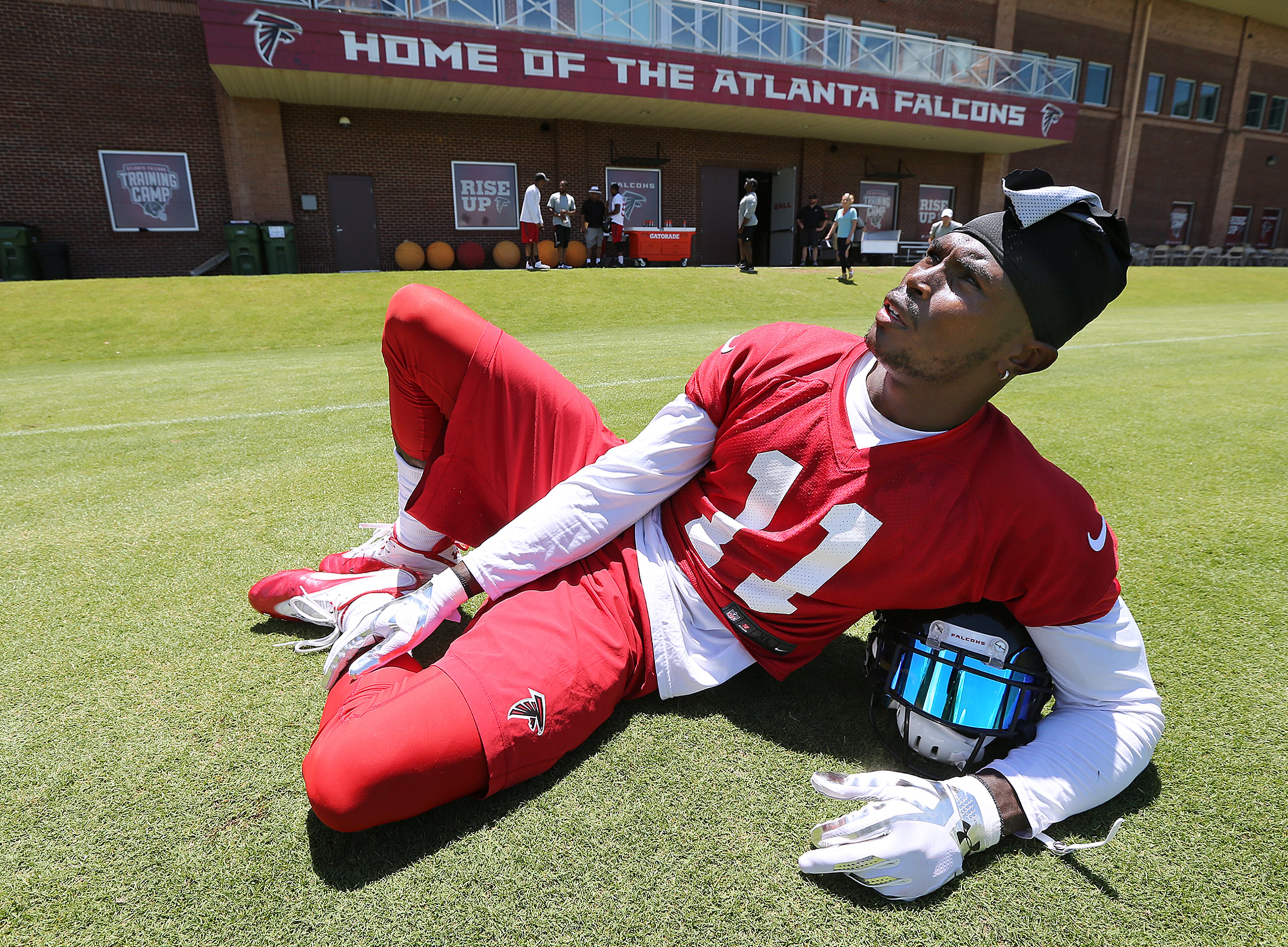 Falcons wide receiver Julio Jones relaxes on the field at the end of practice during an OTA day on Tuesday, June 7, 2016, in Flowery Branch. Curtis Compton / ccompton@ajc.com