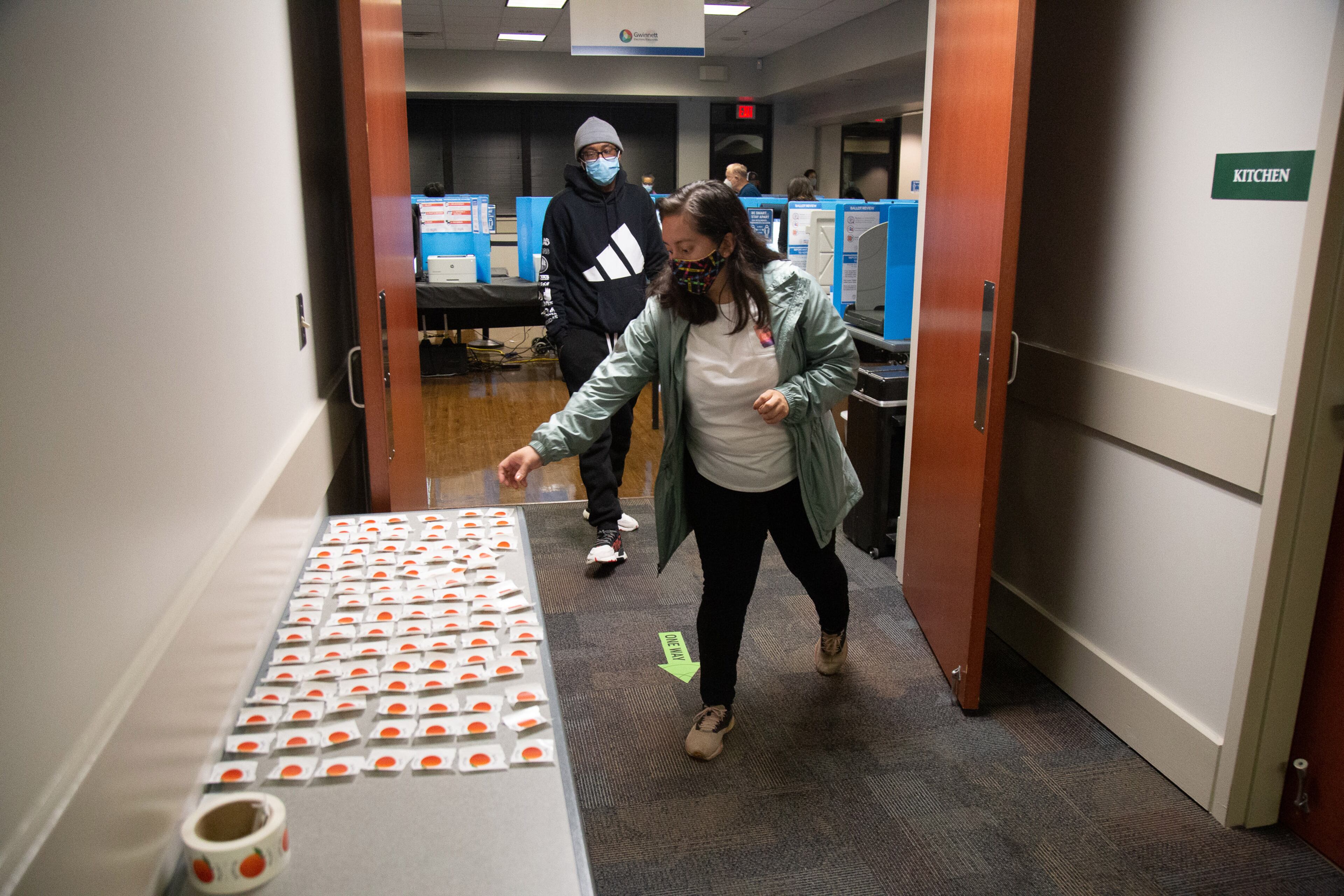 Pilgr Valdez picks up her I Voted sticker after voting at Shorty Howell Park on Saturday, October 24, 2020. STEVE SCHAEFER / SPECIAL TO THE AJC