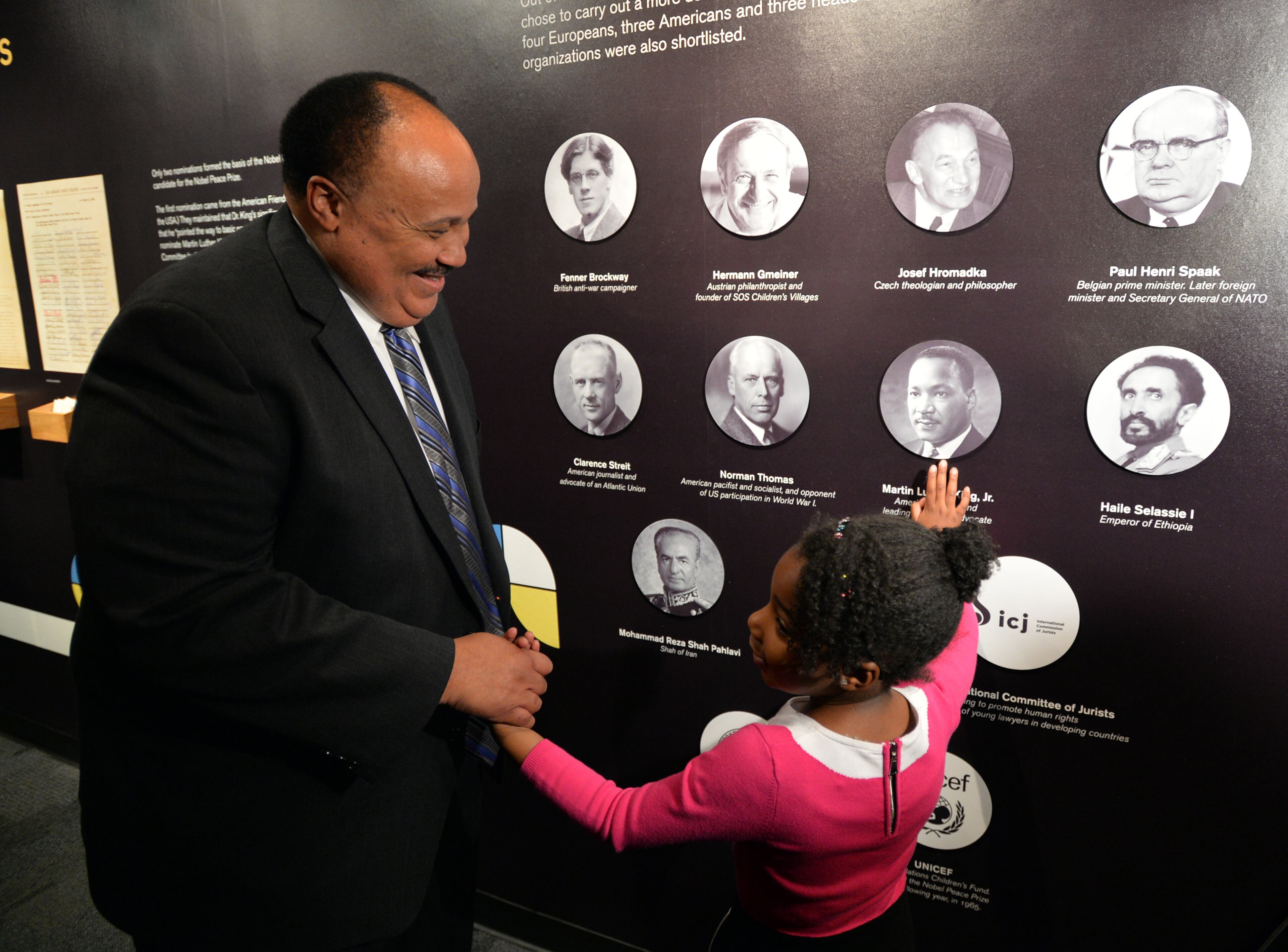 Yolanda Renee King, granddaughter of Martin Luther King Jr. points out a photo of the civil right leader on Dec. 10, 2014. She was with her father, Martin Luther King Jr. III. The two were attending the grand opening exhibition of "1964 Martin Luther King, Jr.", at the Martin Luther King, Jr. National Historic Site. Since 1964, the documents relating to the Nobel Peace Prize award nominations have been classified as a secret, and kept under lock and key in the Norwegian Nobel Committee's extensive archive. BRANT SANDERLIN / BSANDERLIN@AJC.COM