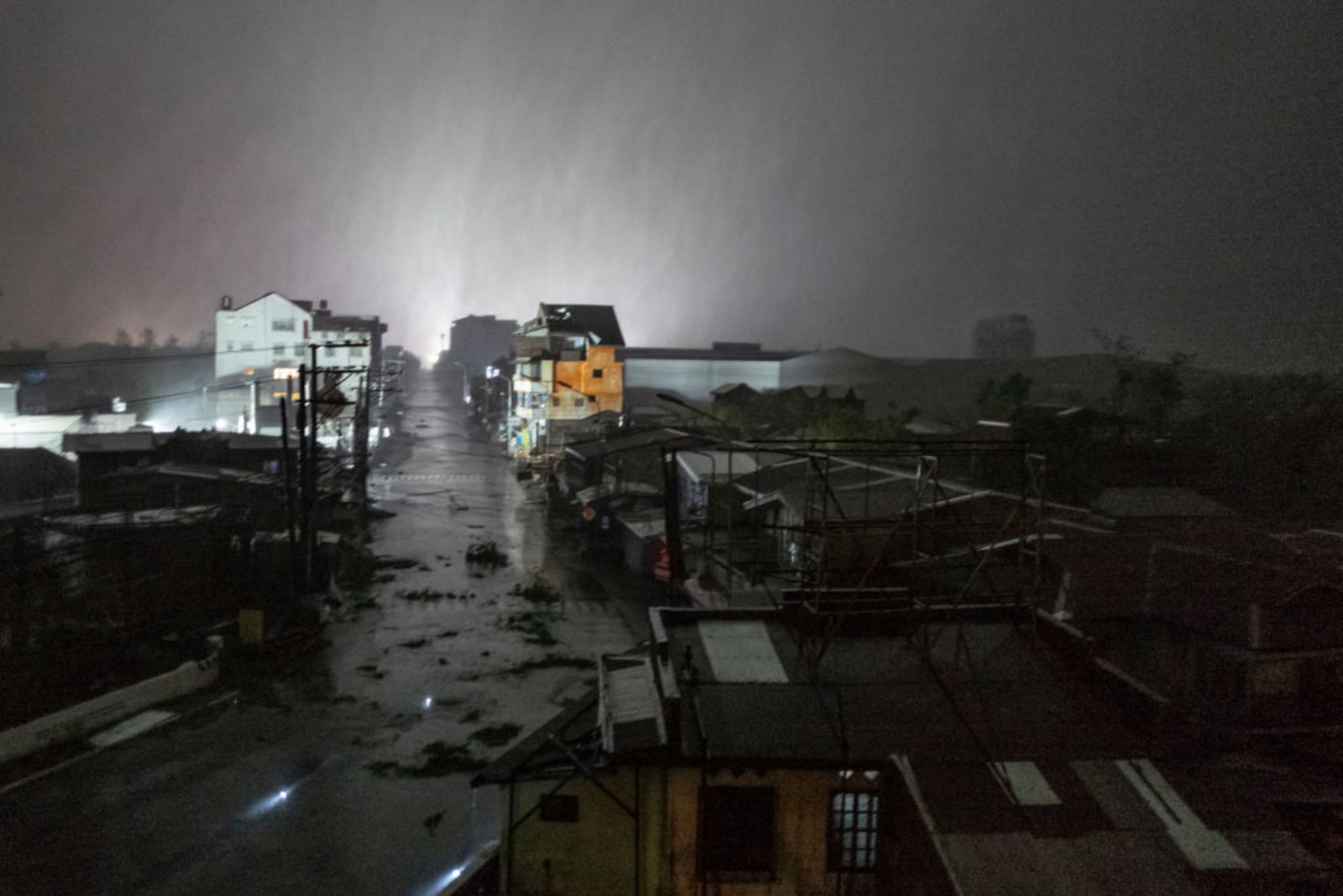 TUGUEGARAO, PHILIPPINES - SEPTEMBER 15: Rains cover the city as strong winds batter houses and buildings lying on the path of Typhoon Mangkhut as it makes landfall on September 15, 2018 in Tuguegarao city, northern Philippines. Mangkut is expected to land Saturday and officials have ordered evacuations and school closures with millions of people in the storms predicted path. The category five storm would be the strongest to hit this year, with wind gusts already at 270 kilometres an hour. (Photo by Jes Aznar/Getty Images)