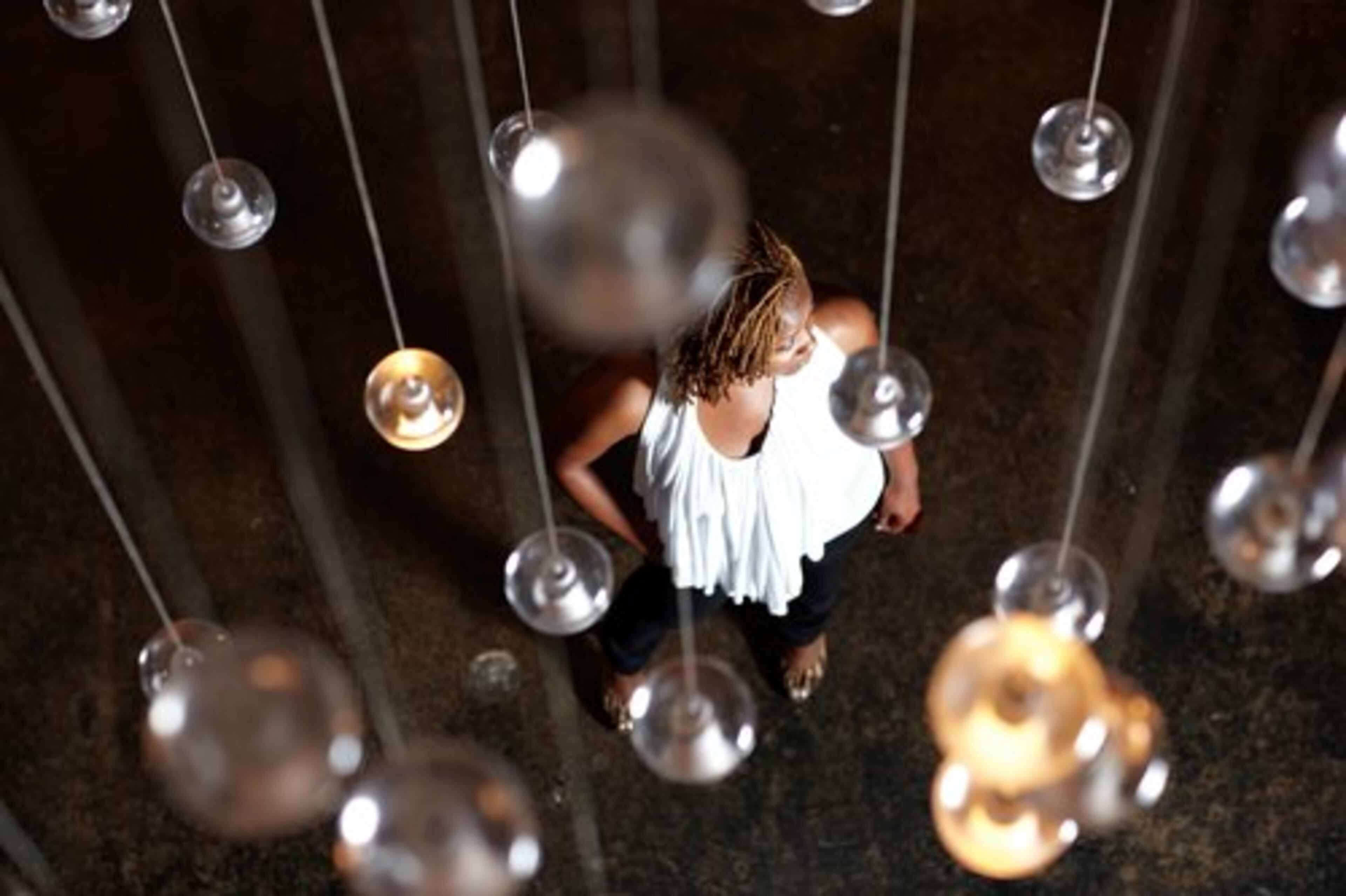 Stroud stands in the lobby of the W Midtown hotel wearing a white halter top with flowing neckline from Arden B. along with a pair of black skinny jeans from Envy.