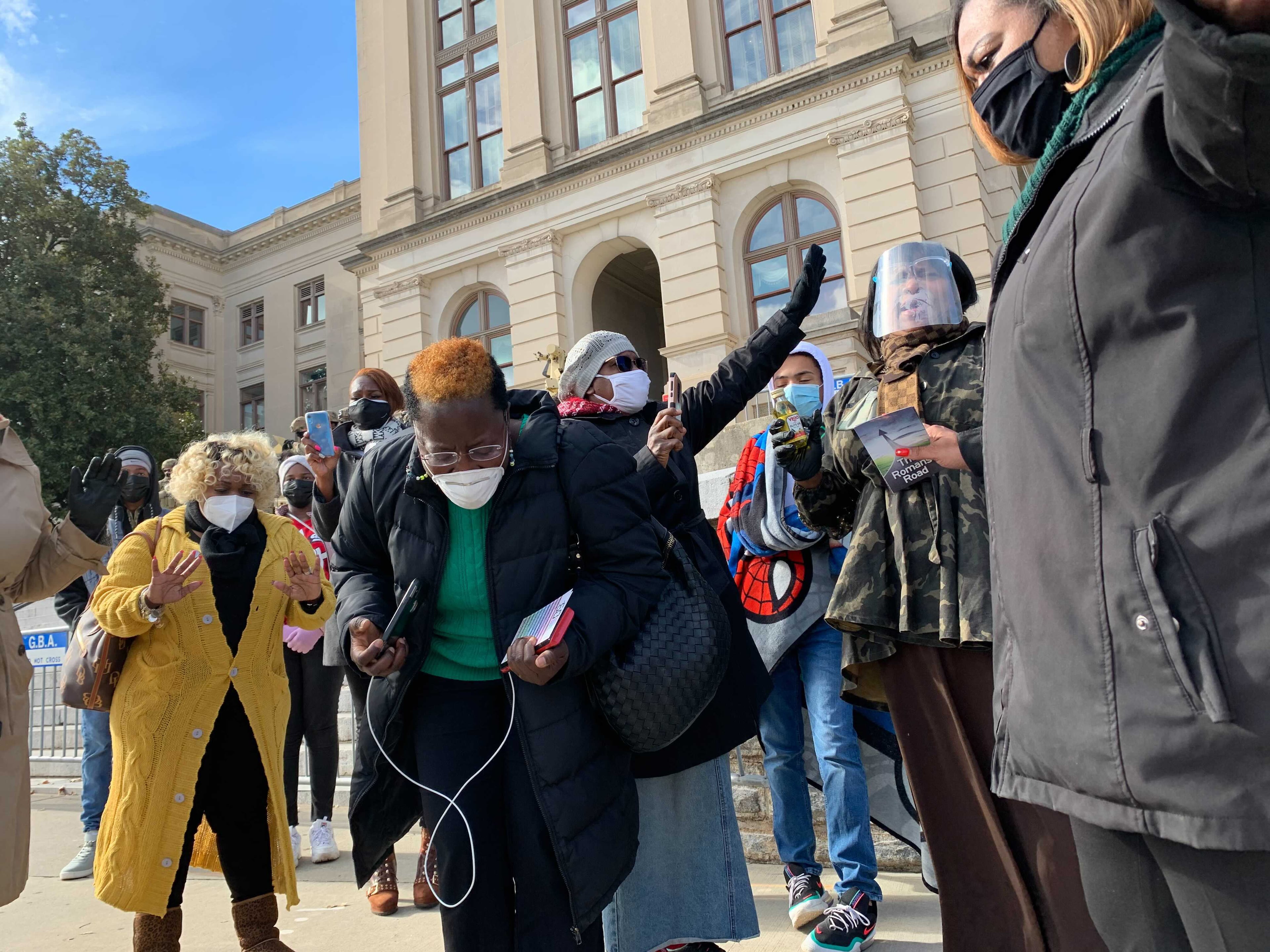 Jan. 17, 2021 — ATLANTA — More than a dozen worshippers from Divine Deliverance Life Center in College Park just prayed outside the state Capitol against more insurrections. (Jeremy Redmon / Jeremy.Redmon@ajc.com