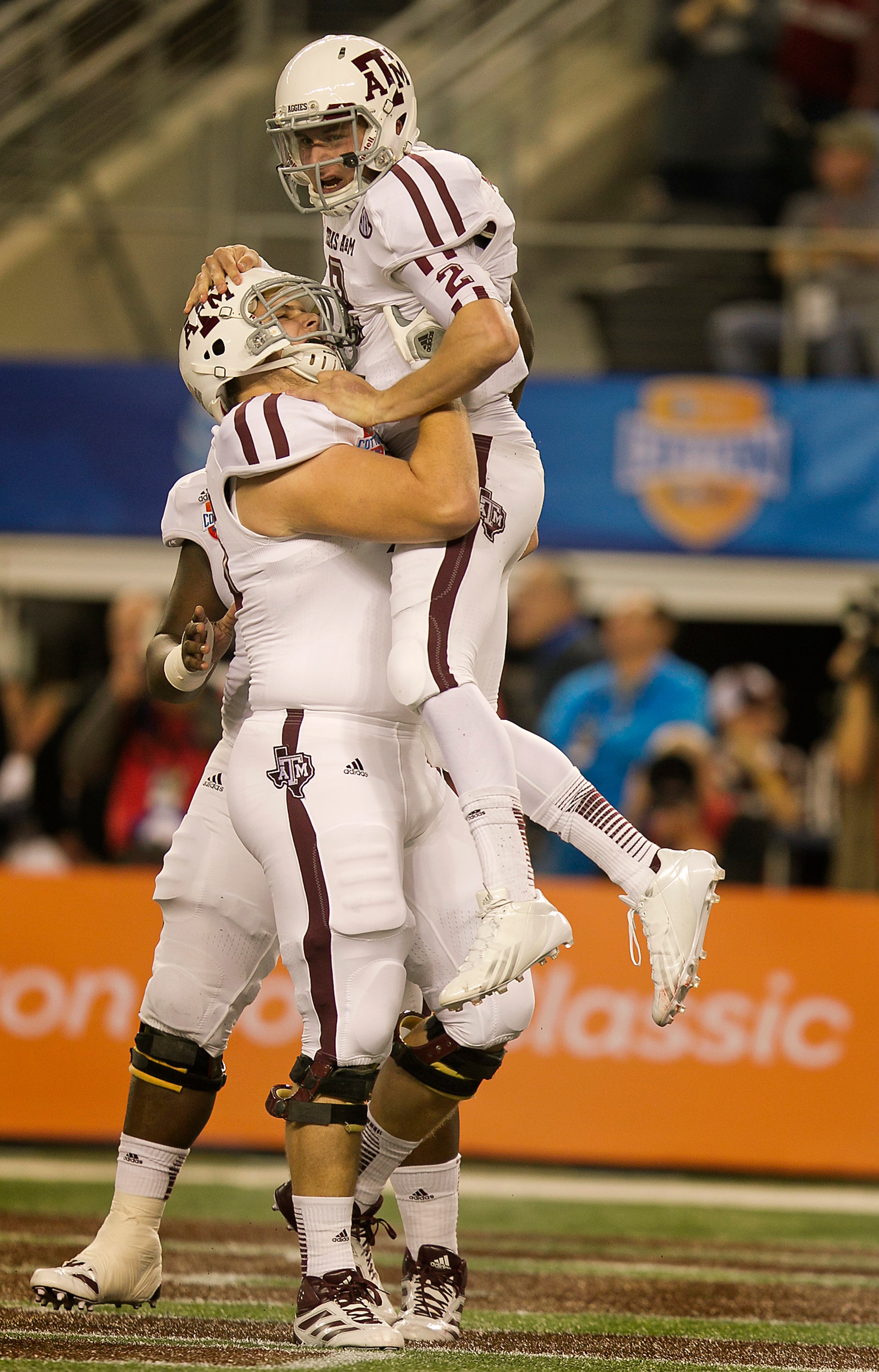 Texas A&M's Johnny Manziel (2) celebrates with Luke Joeckel (76) after scoring on a 23-yard run against Oklahoma during the first half of the 77th AT&T Cotton Bowl Classic held at the Cowboy Stadium in Arlington, Texas, on Friday, January 4, 2013. Rodolfo Gonzalez / Austin American-Statesman